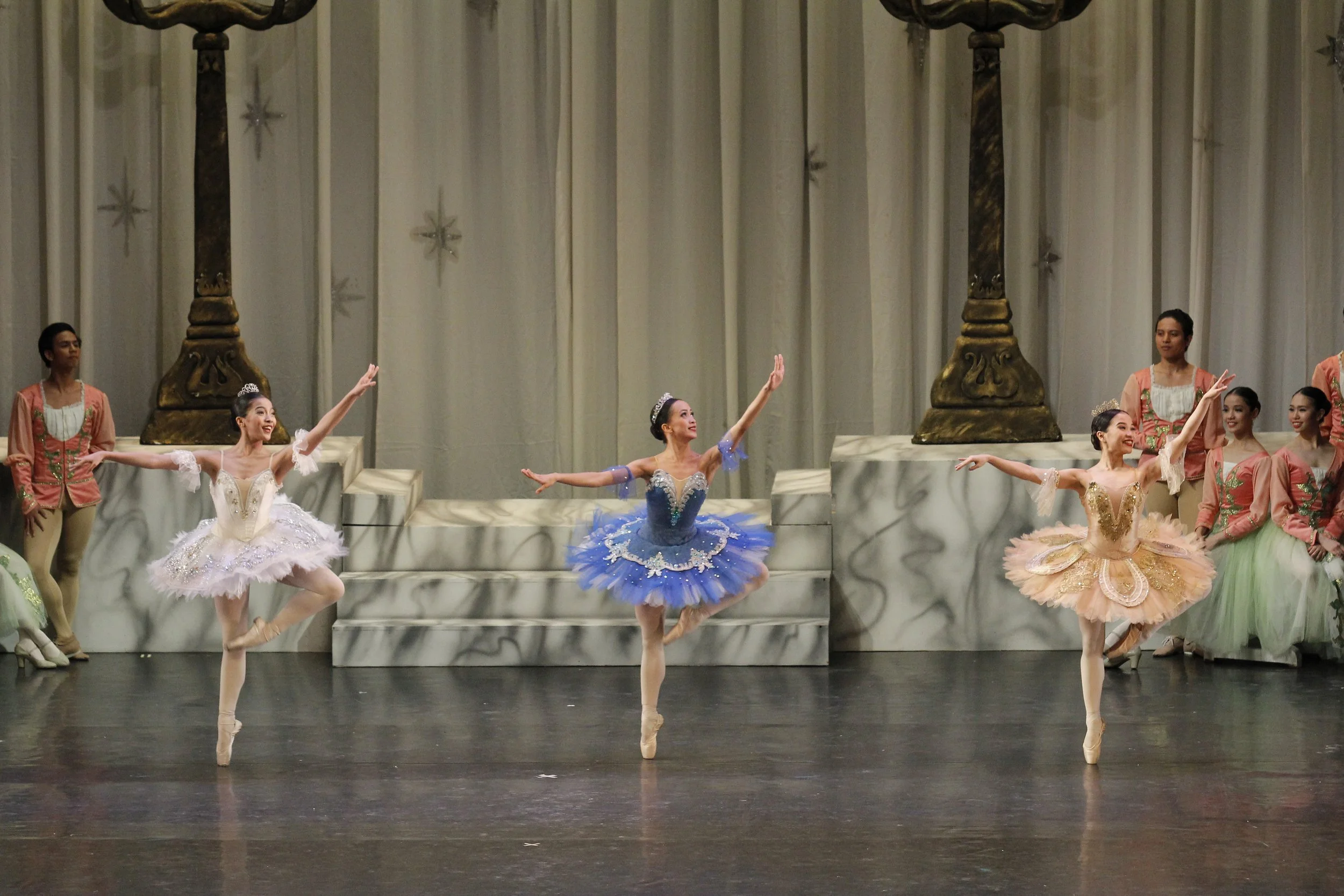    Three fairy godmothers (from left, Nicole Barroso, Jessa Balote and Jasmine Pia Dames) heed the Lilac Fairy’s call to come to the aid of Princess Aurora who has been cursed into an eternal slumber. The scene is part of  The Sleeping Beauty  excerp