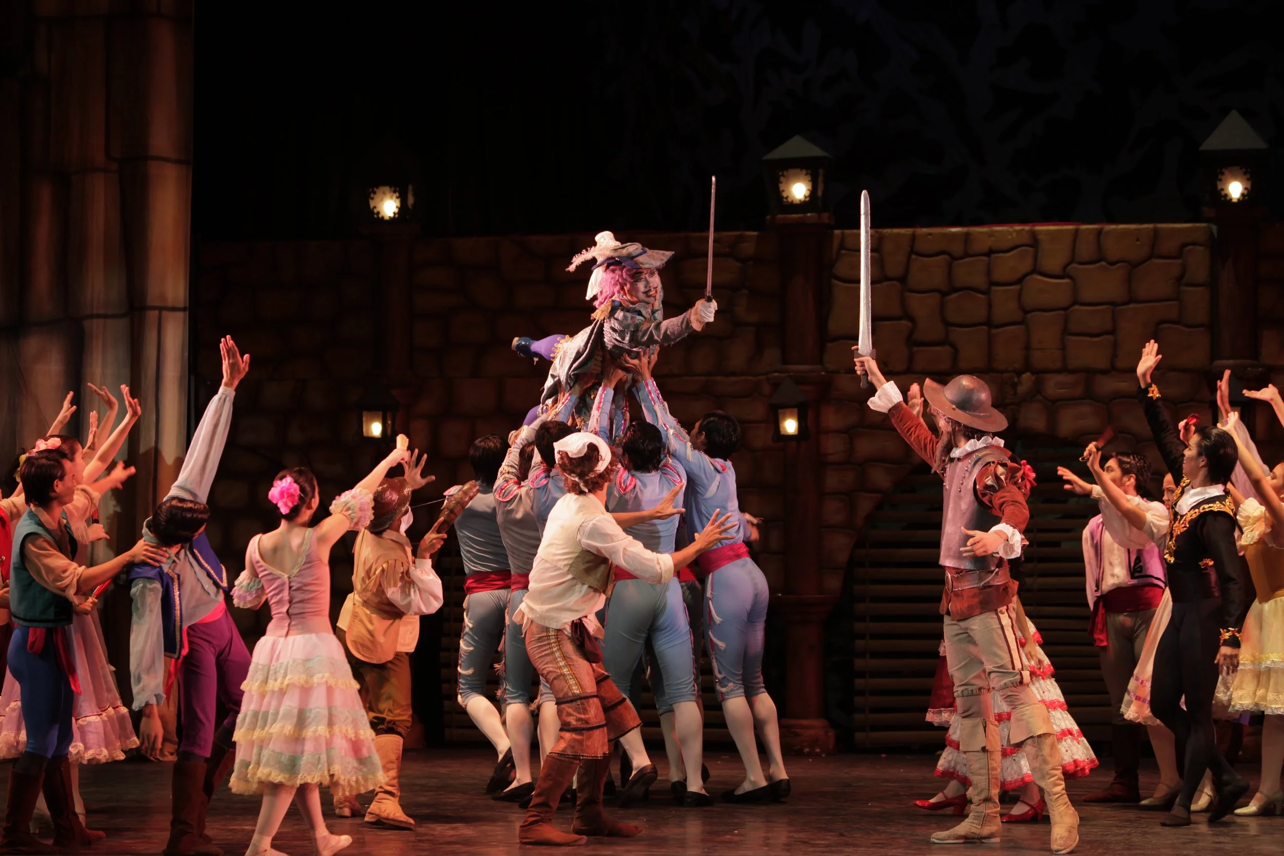    Fancying himself as a knight, Don Quixote (Arnulfo Andrade, right) waves his sword at Gamache (Jonathan Janolo) – Kitri’s unwanted suitor – who similarly seems ready to engage in a duel with the wandering nobleman. But he is playfully carried off 