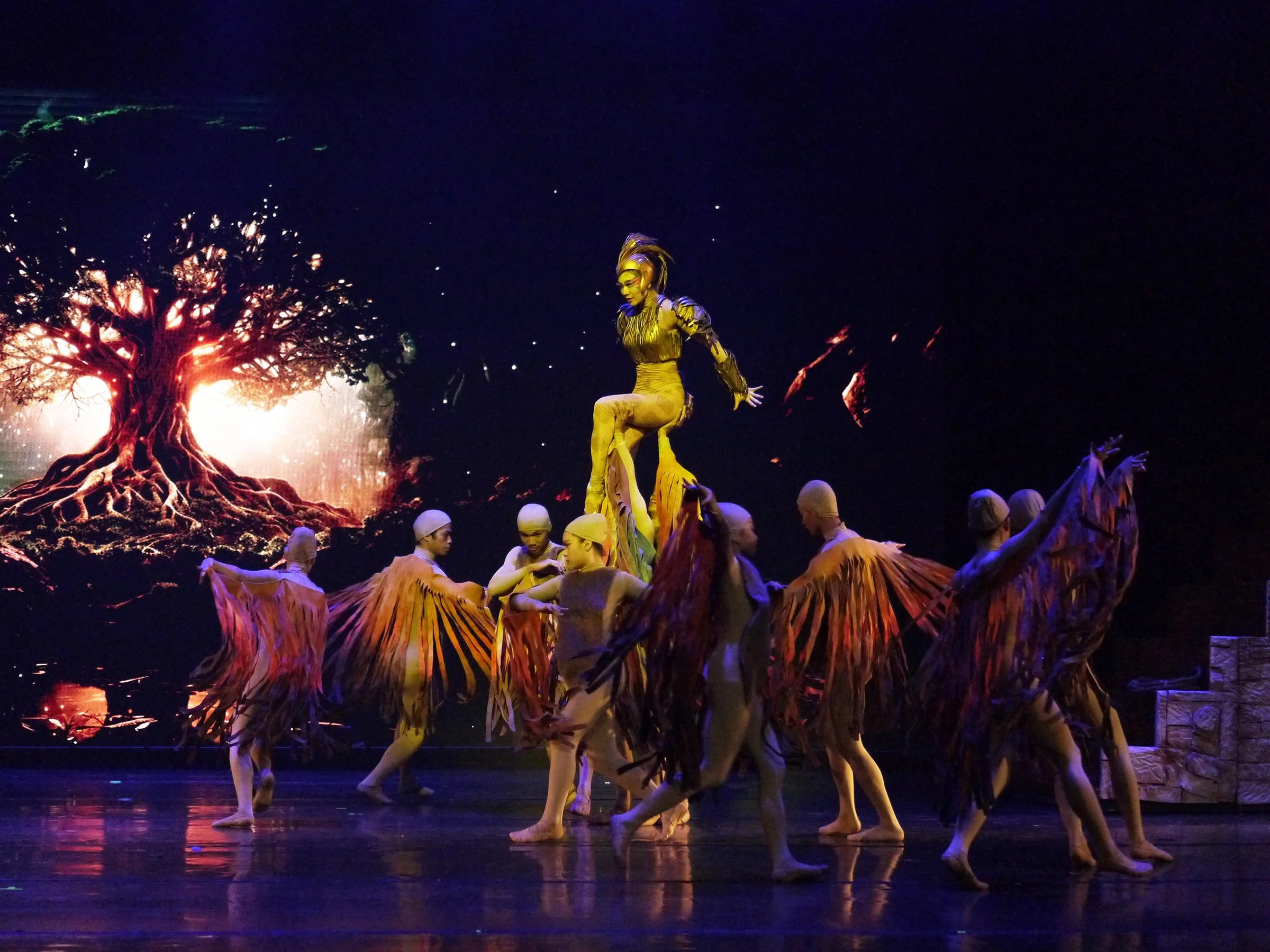    Abigail Oliveiro as the Ibong Adarna makes a majestic appearance with her multi-colored feathers framing her in this scene from Gerardo Francisco Jr.’s ballet adaptation of the Filipino literary classic. In  Ibong Adarna  (2024), the mythical wing