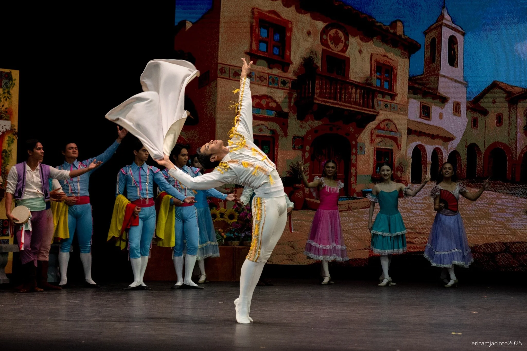    Espada (Mark Sumaylo) stands out in this scene from  Don Quixote  (2025) not just for his all-white toreador’s ensemble, but for that amazing back bend he launches into as he twirls his cape. The “showdown” between Espada and romantic interest Mer