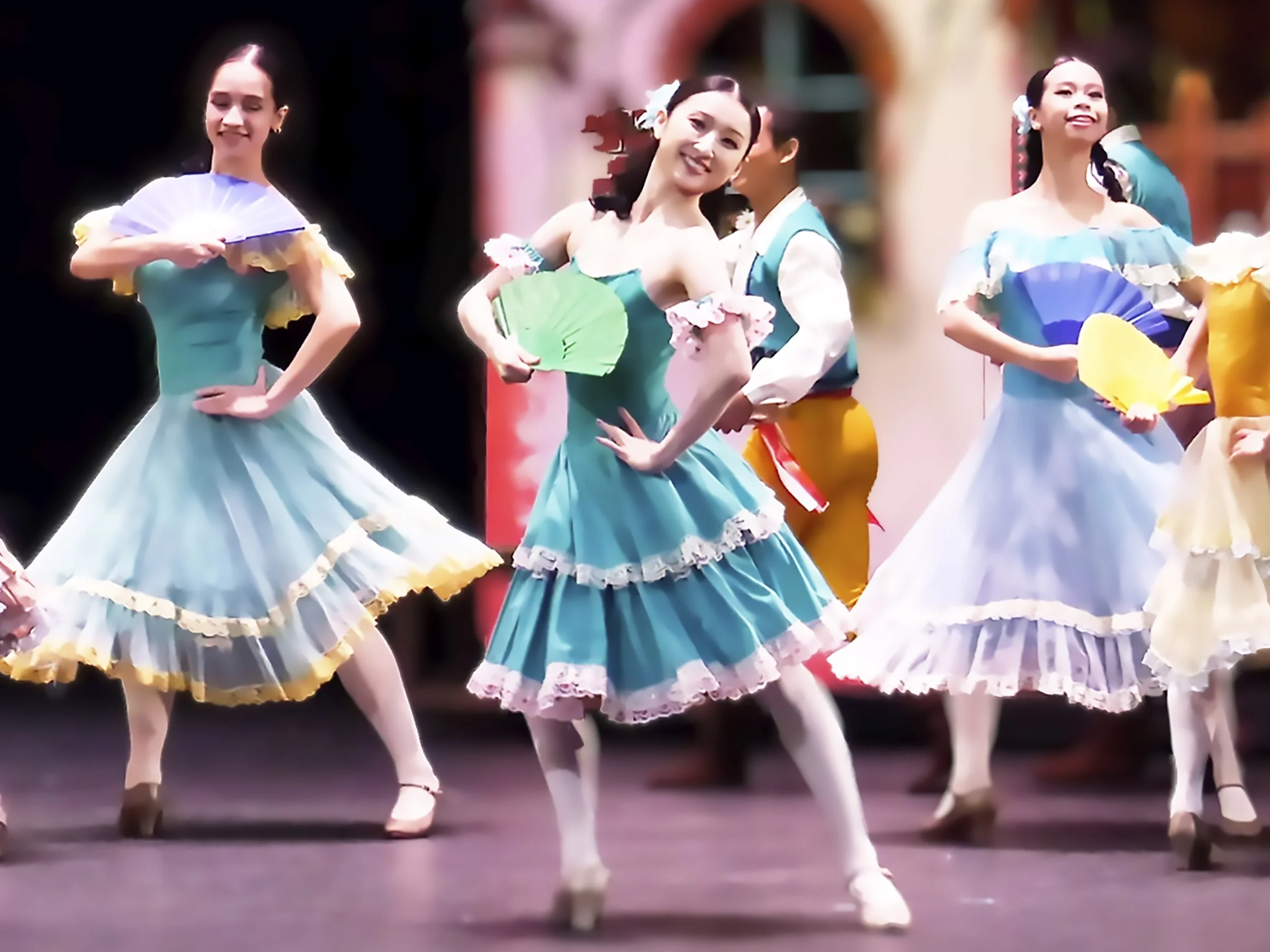    A teal fan is the perfect accessory to go with this flouncy teal dress worn by one of the village girls (Nanami Hasegawa) in  Don Quixote  (2025). Merriment erupts in the plaza as Kitri and Basilio evade her disapproving father to steal some momen
