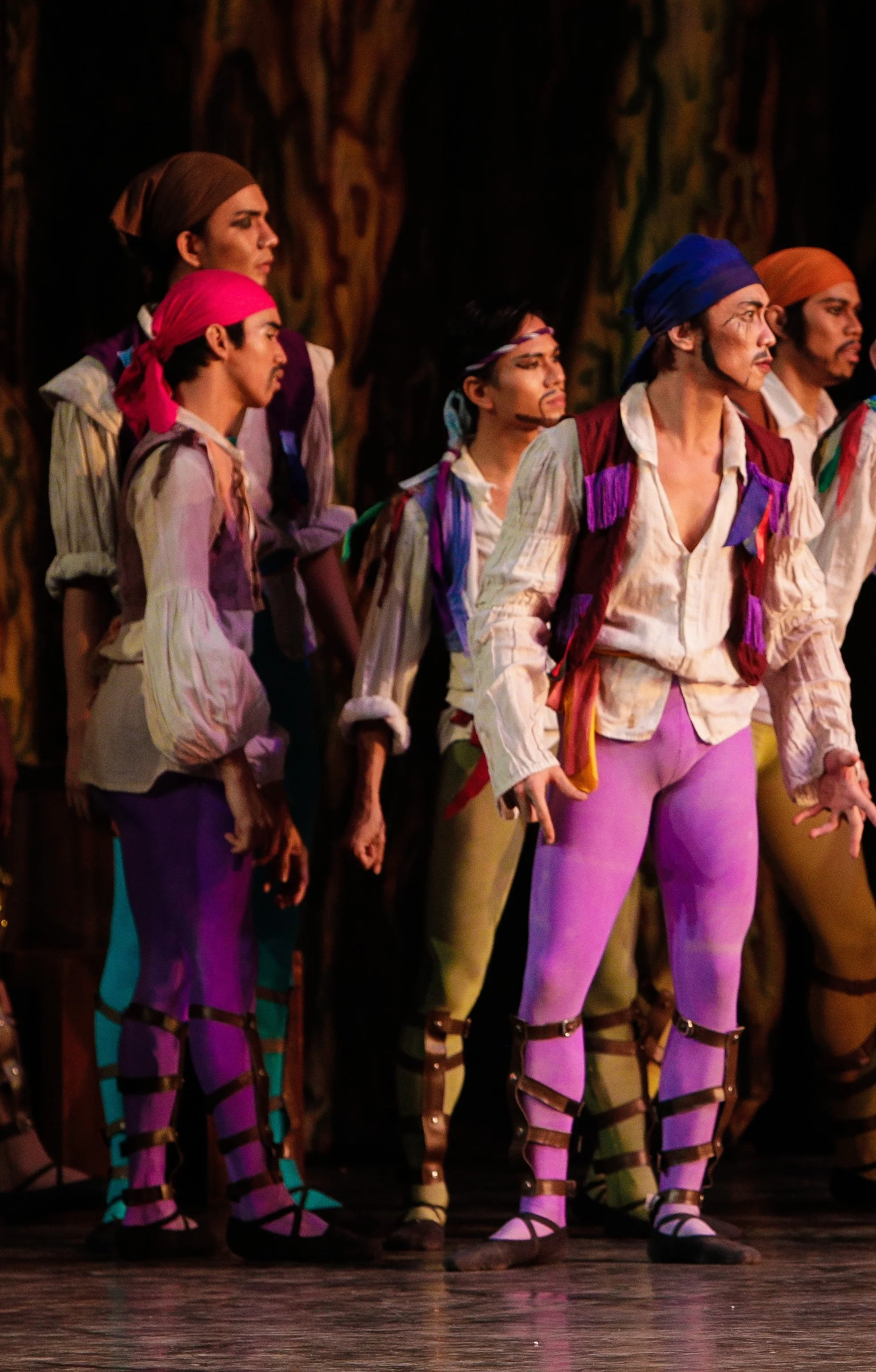    The pirates in  Le Corsaire  (2013) are brave and bold not just in their demeanor but in their choice of colors. Two of them are shown in shades of violet, ready for action at as they embark on adventures with their leader Conrad. Photo by Jojo Ma