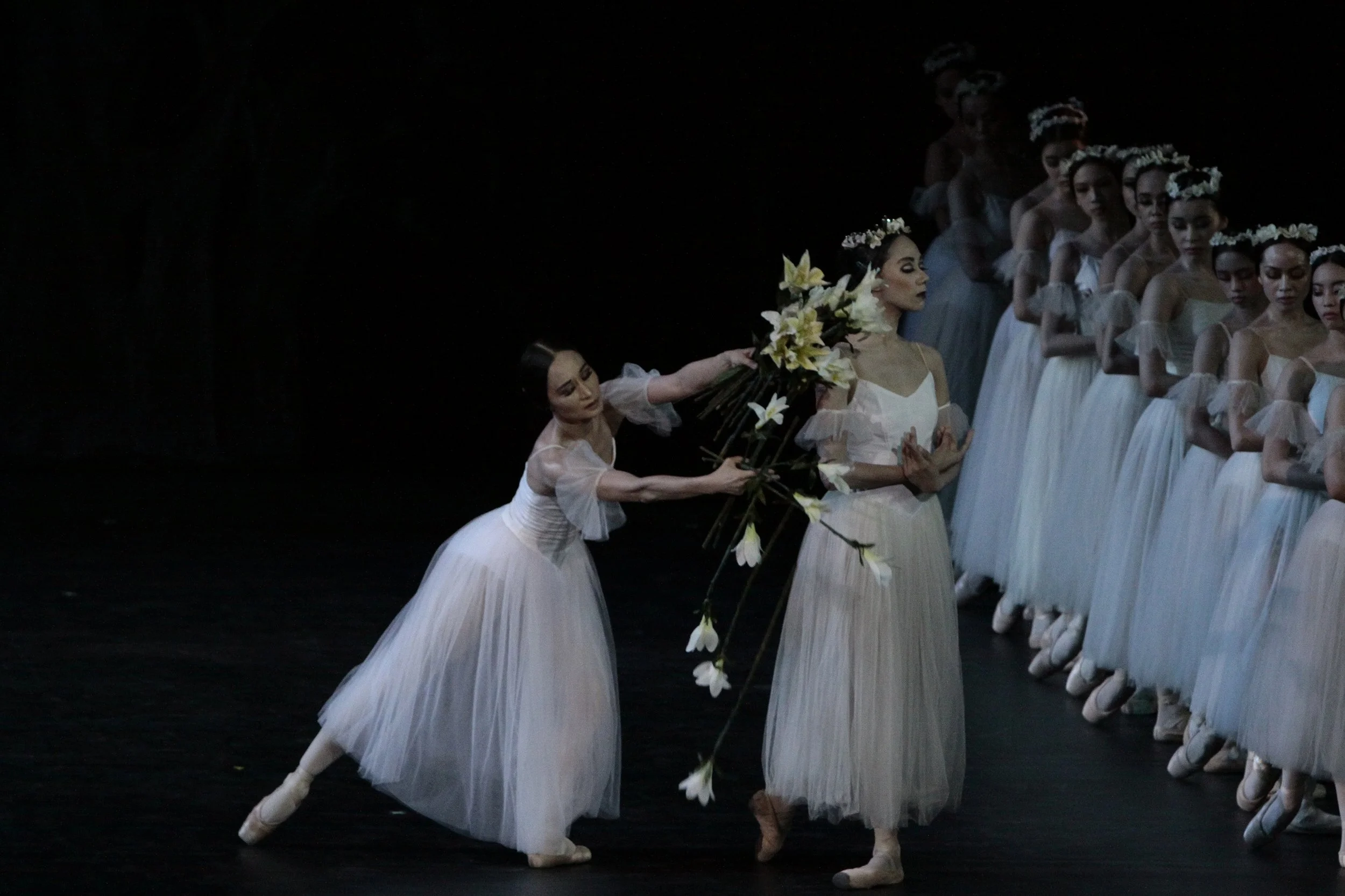    Giselle (Lisa Macuja Elizalde) makes an offering of lilies to Myrtha (Zaira Cosico) in  Giselle  (2010) as she begs the queen of the wilis – spirits of girls who were wronged by men – to spare her beloved Albrecht’s life. Photo by Ocs Alvarez   