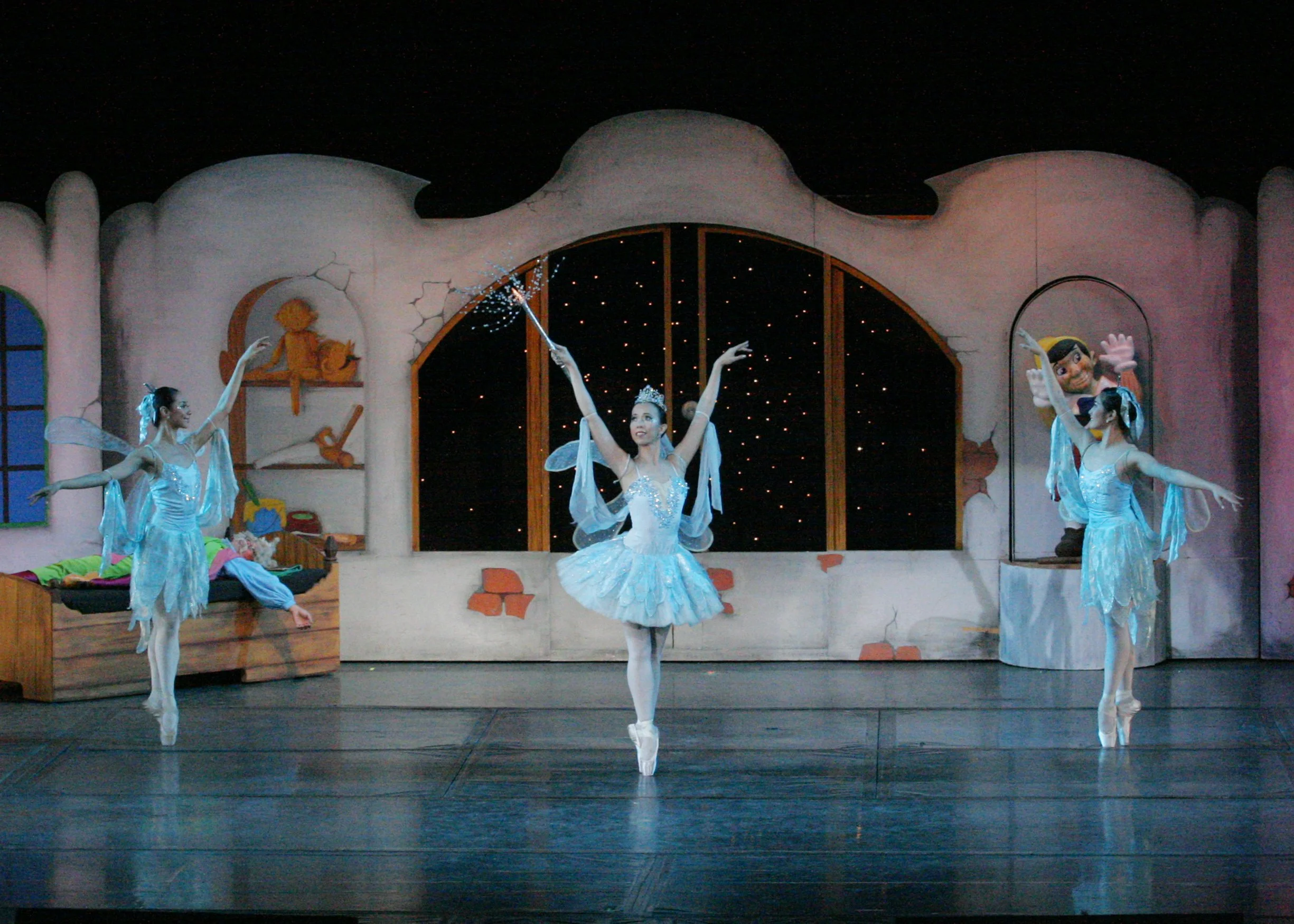    The Blue Fairy (Eileen Lopez, center) is named so as her tutu, just like those of her companions, is in a delicate shade of blue. She is about to wield her magic in Osias Barroso Jr.’s  Pinocchio  (2007) as the wood carver Gepetto has been wishing