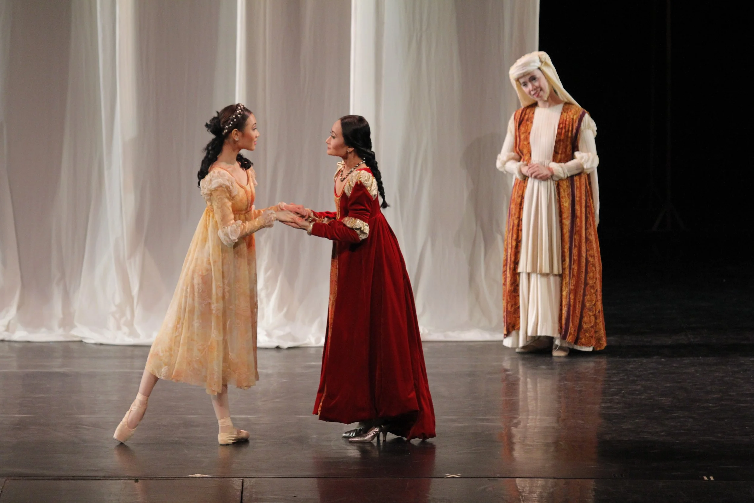    Wanting only the best for her daughter Juliet (Abigail Oliveiro, left), Lady Capulet (Lisa Macuja Elizalde) assures her that Paris will be a good match for her as the nanny (Eileen Lopez) witnesses this tender moment. The scene is from Paul Vaster