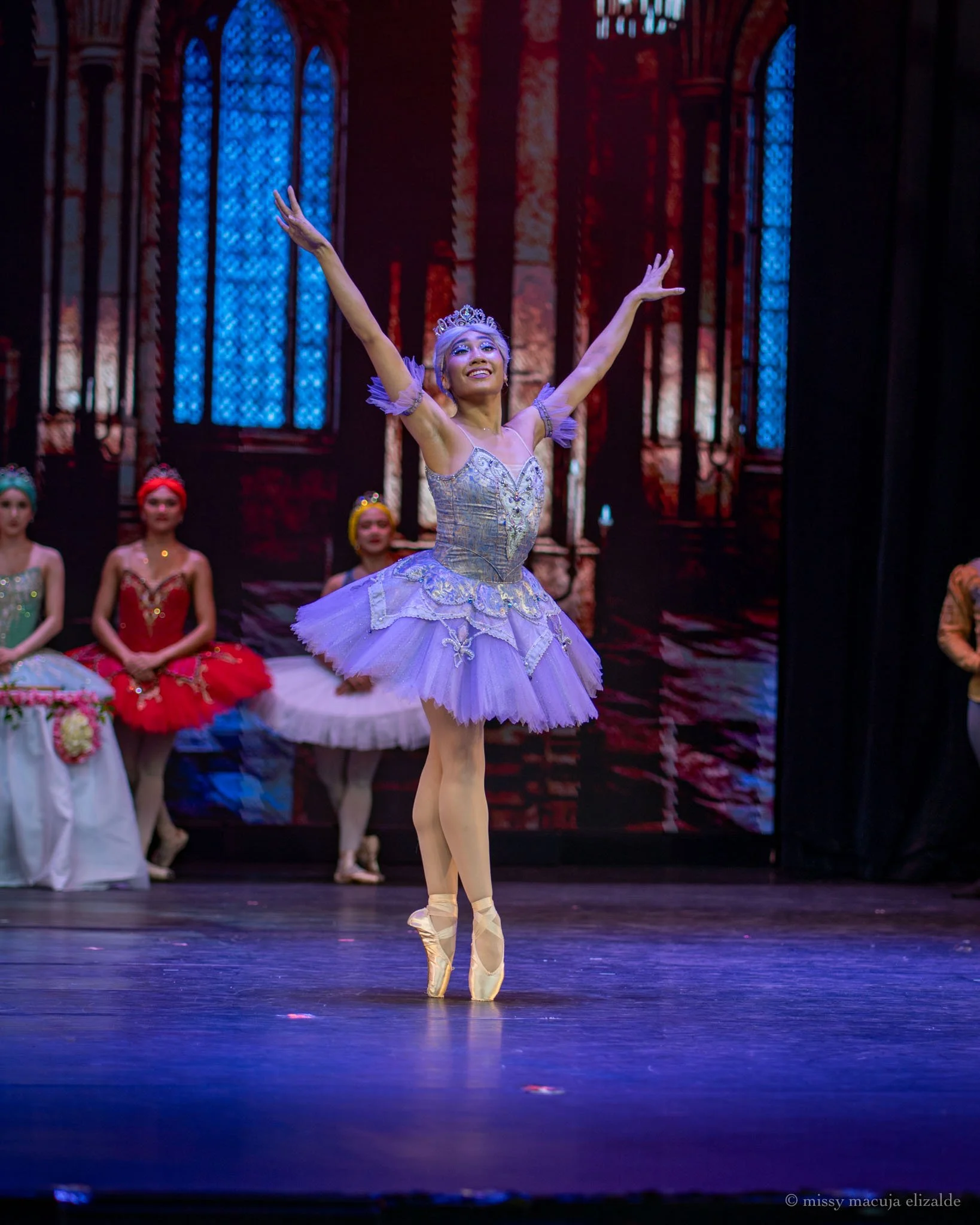    As the Lilac Fairy in Lisa Macuja Elizalde’s  Sleeping Beauty  (2026), Stephanie Santiago dons – what else but – lilac! In this scene from Ballet Manila’s Prima season-opener, her character has marshalled her fellow fairies to welcome the birth of
