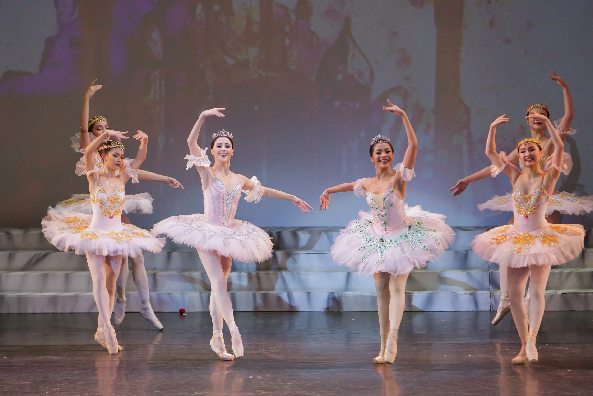    Medora (Katherine Barkman) and Gulnara (Nicole Barroso) make a perfect pair in their complementing pink tutus as they perform in the “living garden” scene in  Le Corsaire  (2018). The corps de ballet is similarly clad in pink, and all together, th