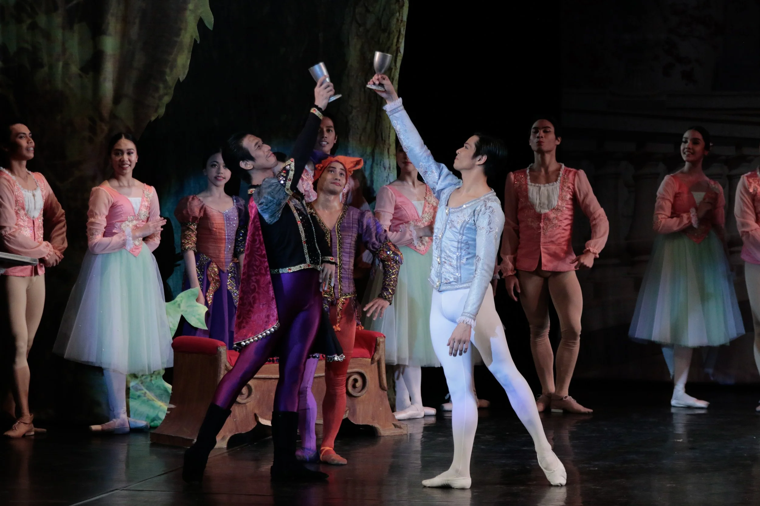    Prince Siegfried (Mark Sumaylo, right) is turning 21 and is in a jovial mood in  Swan Lake  (2017). His friend and confidant Benno (Neil John Mag-aso) joins him for a celebratory swig, as the ladies and gentlemen of the royal court and the jester 