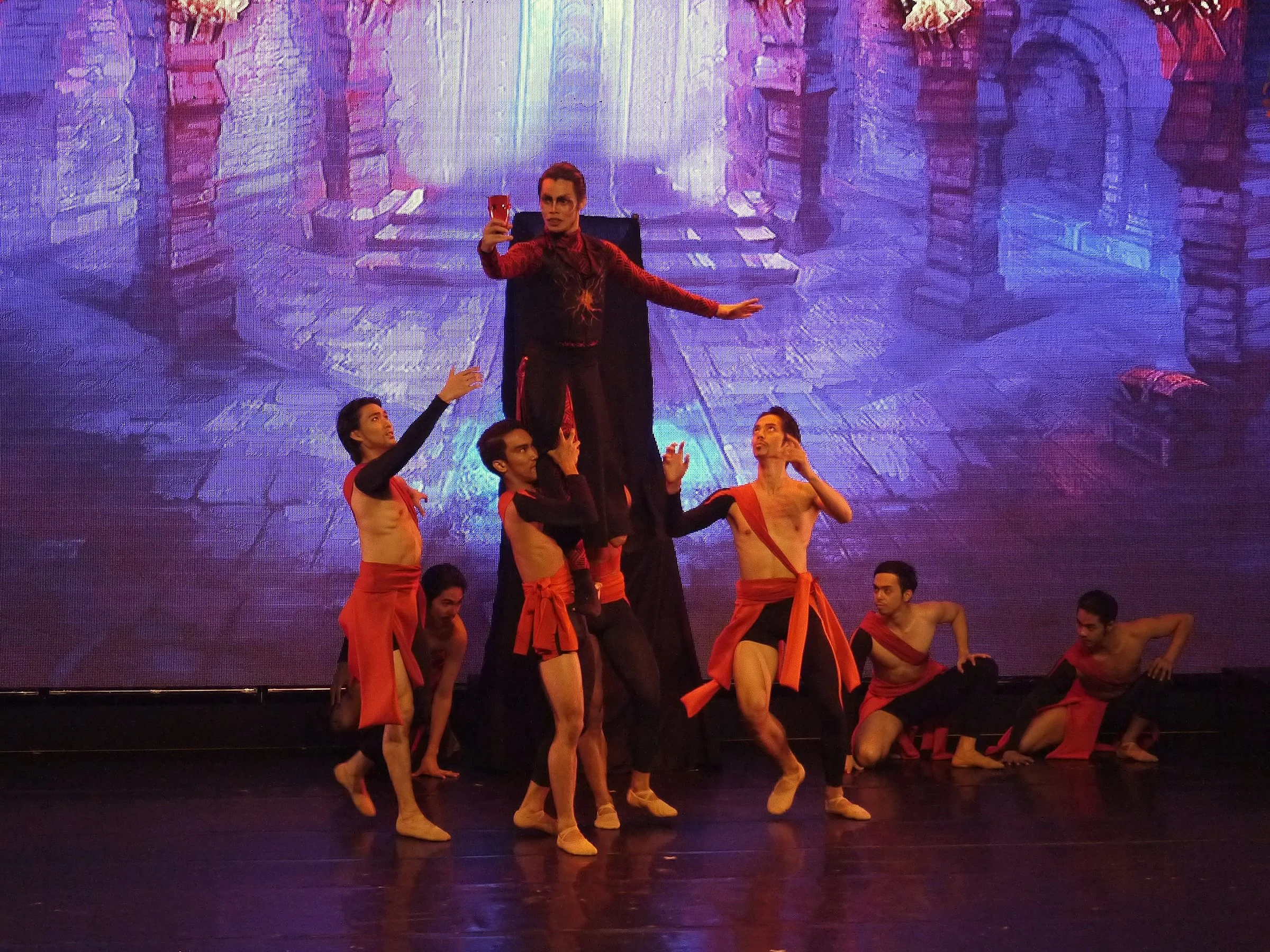    In Rudy De Dios’  Carmina Burana  (2020), the evil being Atheos (John Ralp Balagot) descends on the city of Tezra which has been plagued by drought. By telling people that their god Agape has abandoned them, he hopes to destroy their faith and win