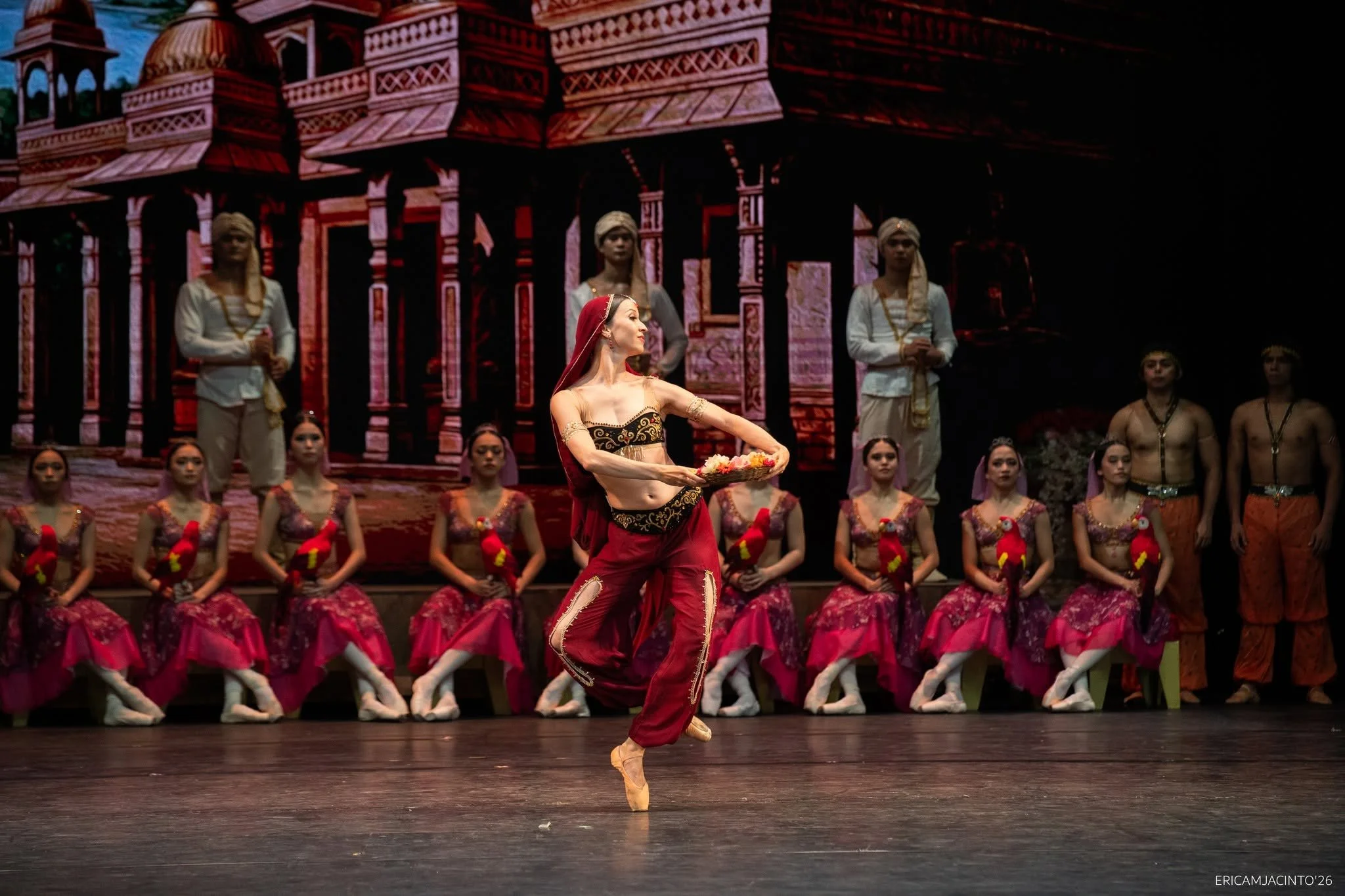    Clothed in a maroon ensemble, her hair covered by a flowing maroon veil, the temple dancer Nikiya (Renata Shakirova) has learned of Solor’s betrayal but must still perform at his betrothal to Gamzatti in  La Bayadere  (2026). At first, she is desp