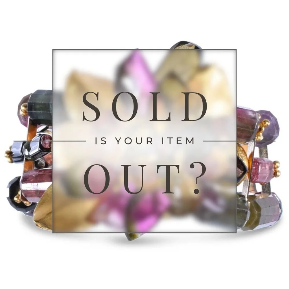A gemstone bracelet with a sold out sign