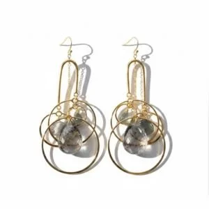 Chandelier earrings of overlapping gold rings around a smoky gemstone, by Andrea Li