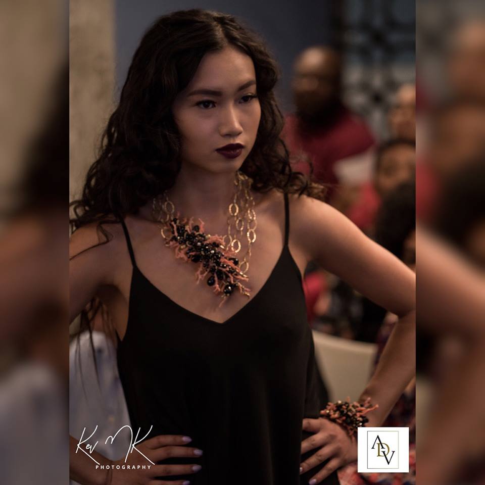 Model wearing branch coral, black spinel, onyx and gold statement necklace