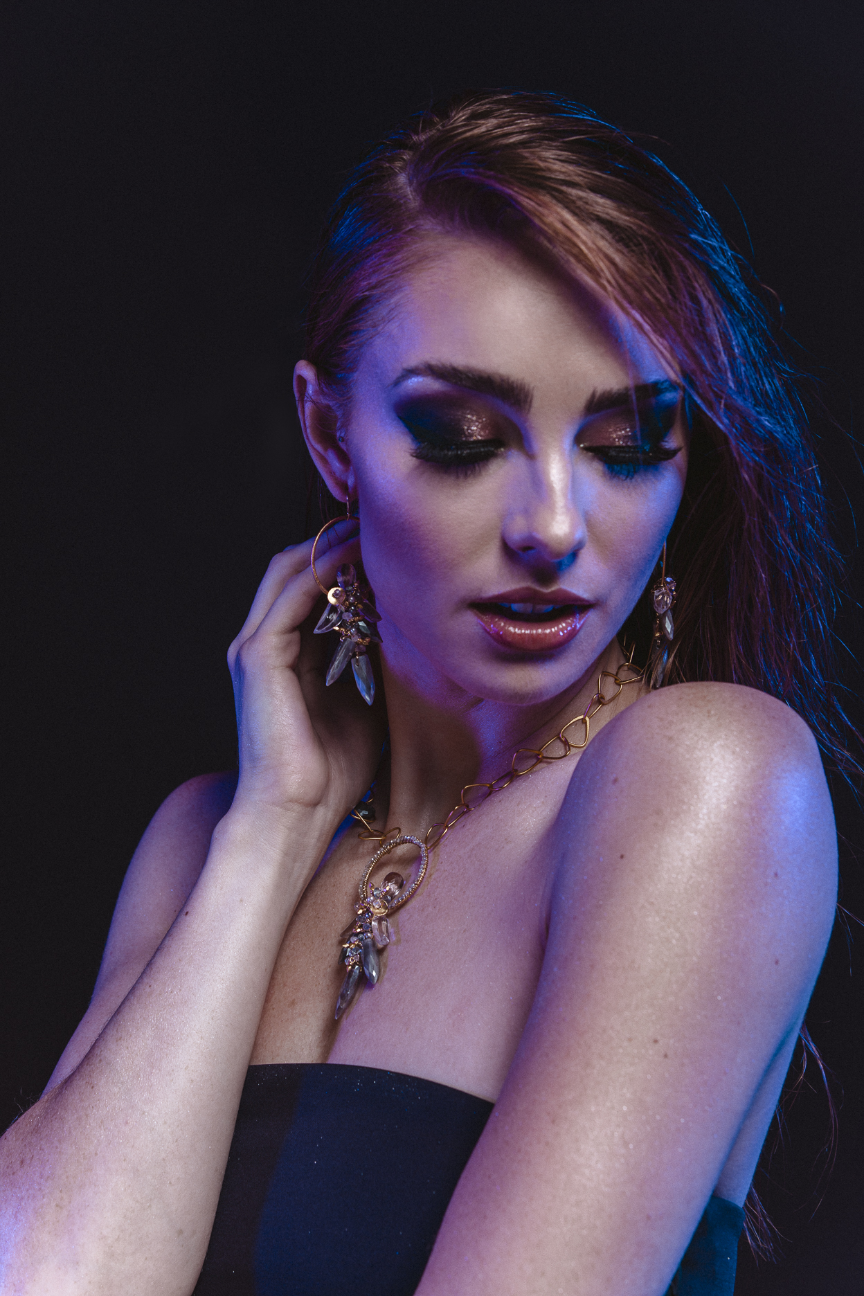 model wearing gemstone hoop earrings