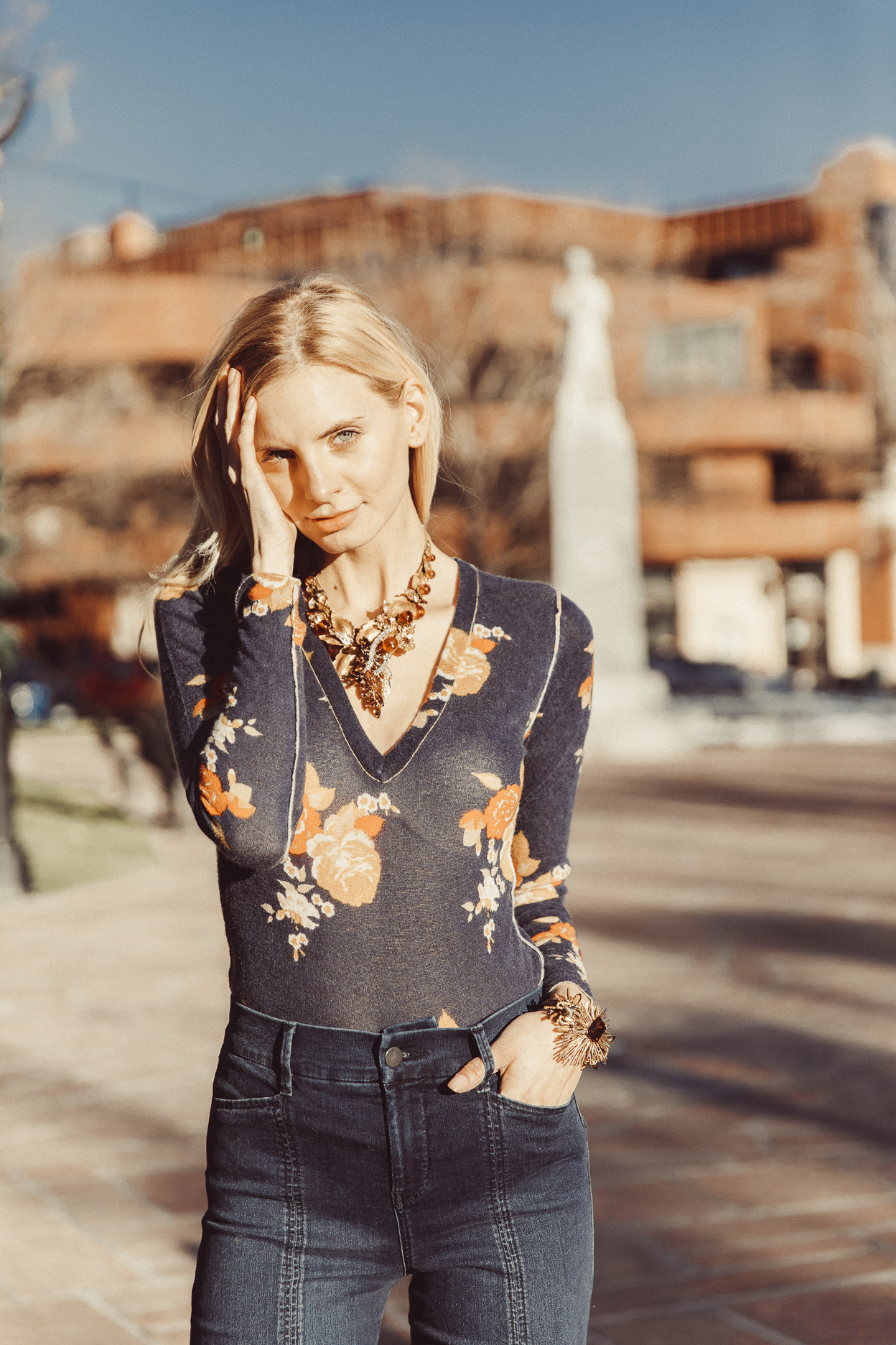 model wearing gold leaf vintage statement necklace and cuff