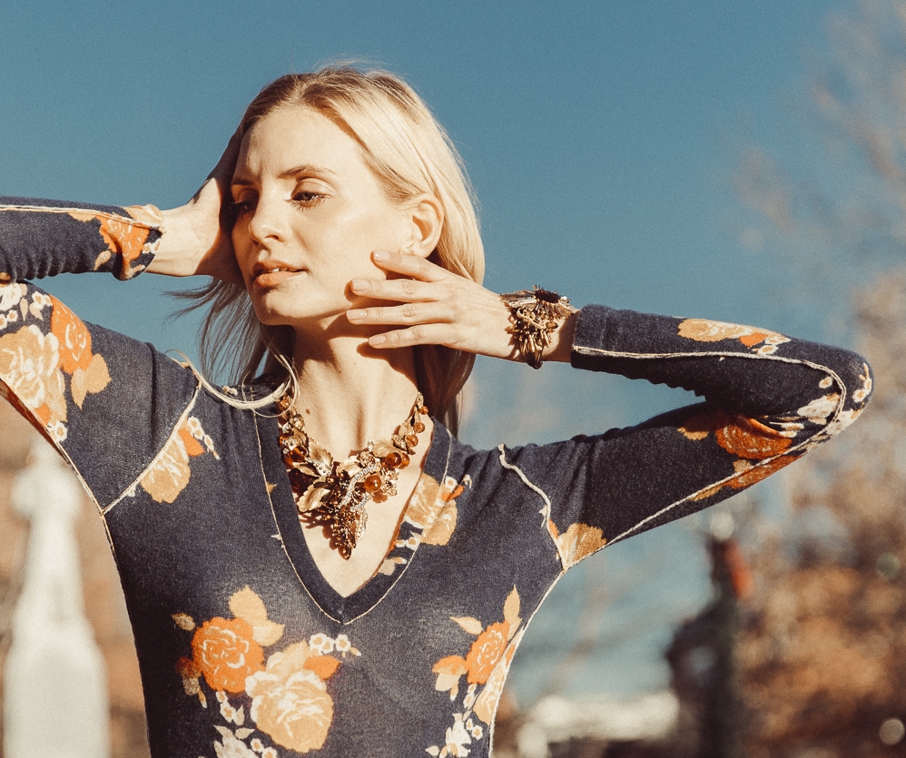 model wearing gold leaf vintage statement necklace and cuff