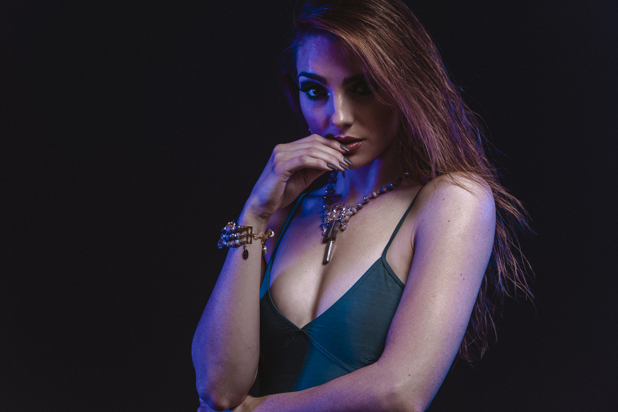 Model wearing statement gemstone and gold cuff bracelet