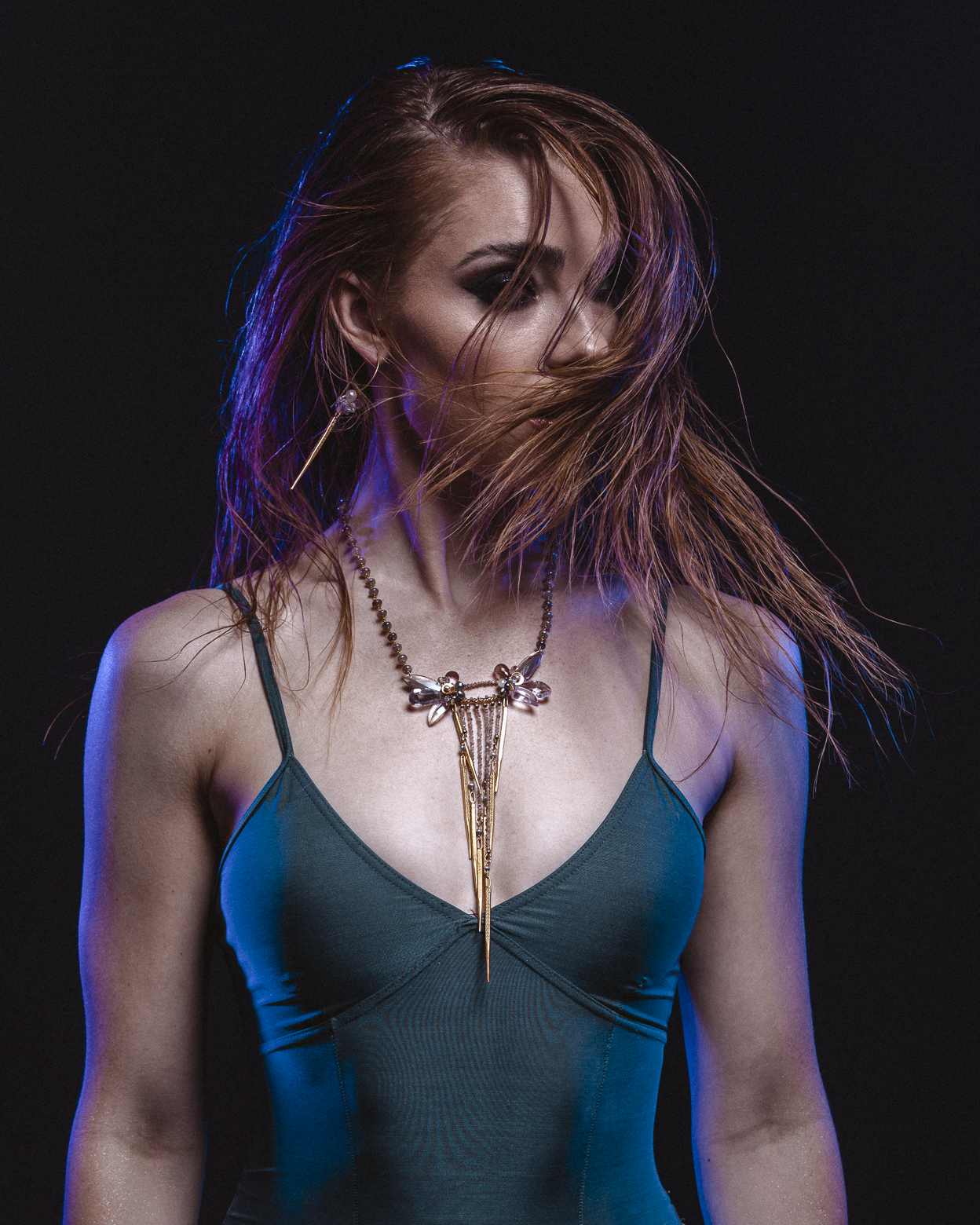 Model wearing long multi drop bib statement gemstone necklace