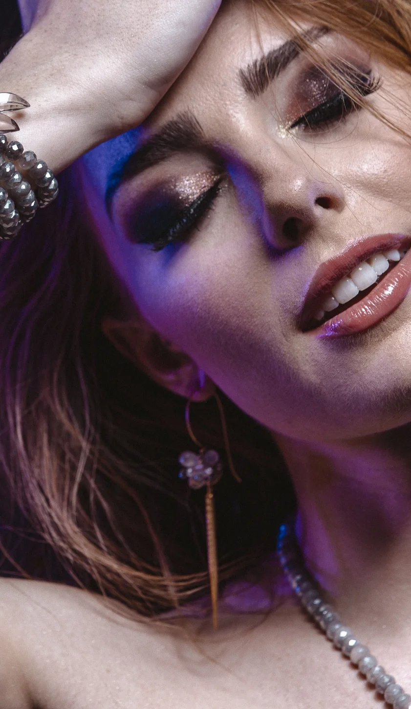 Model wearing long spike pendant gemstone earring