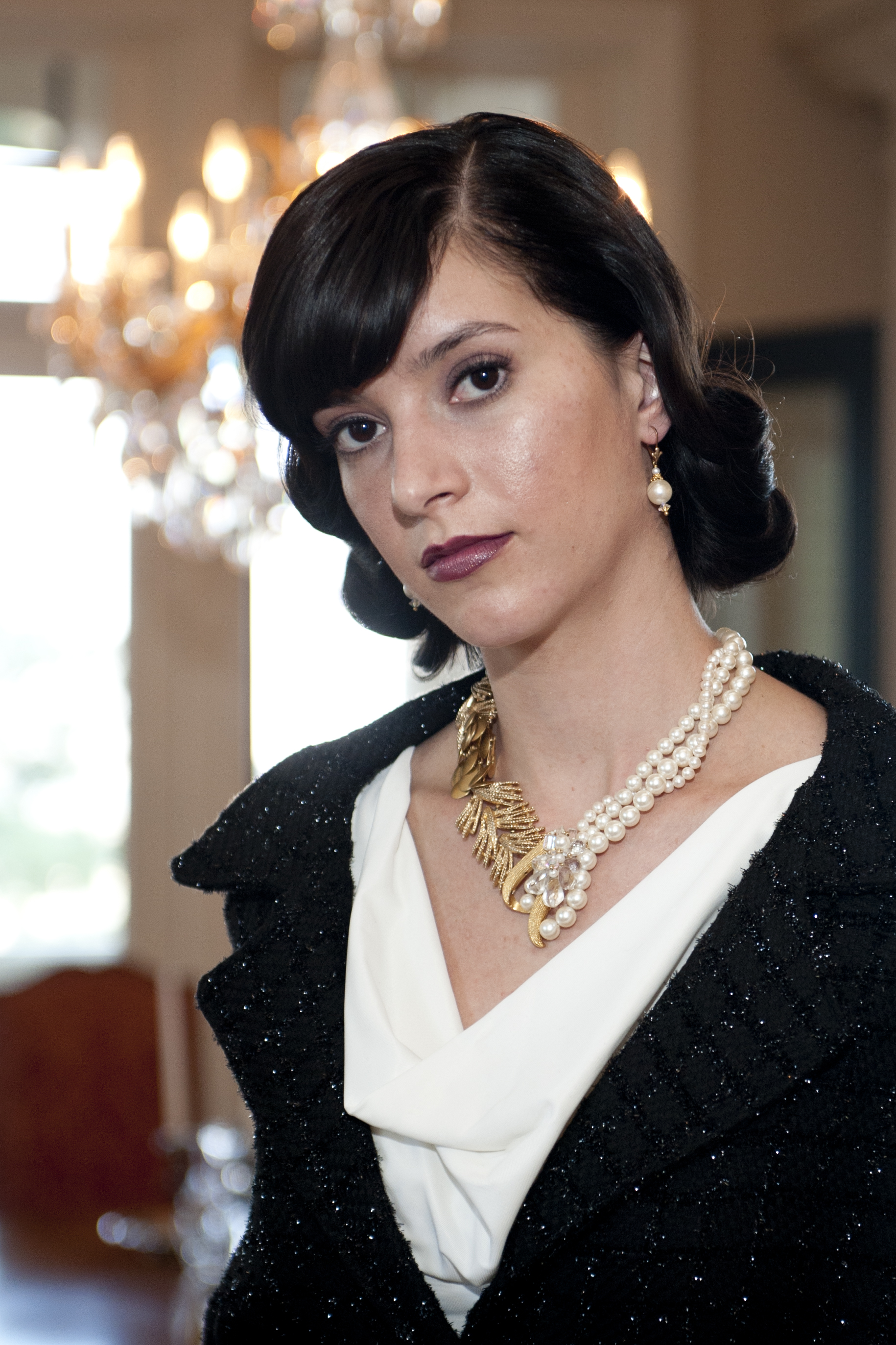 model wearing multi strand pearl necklace with gold details