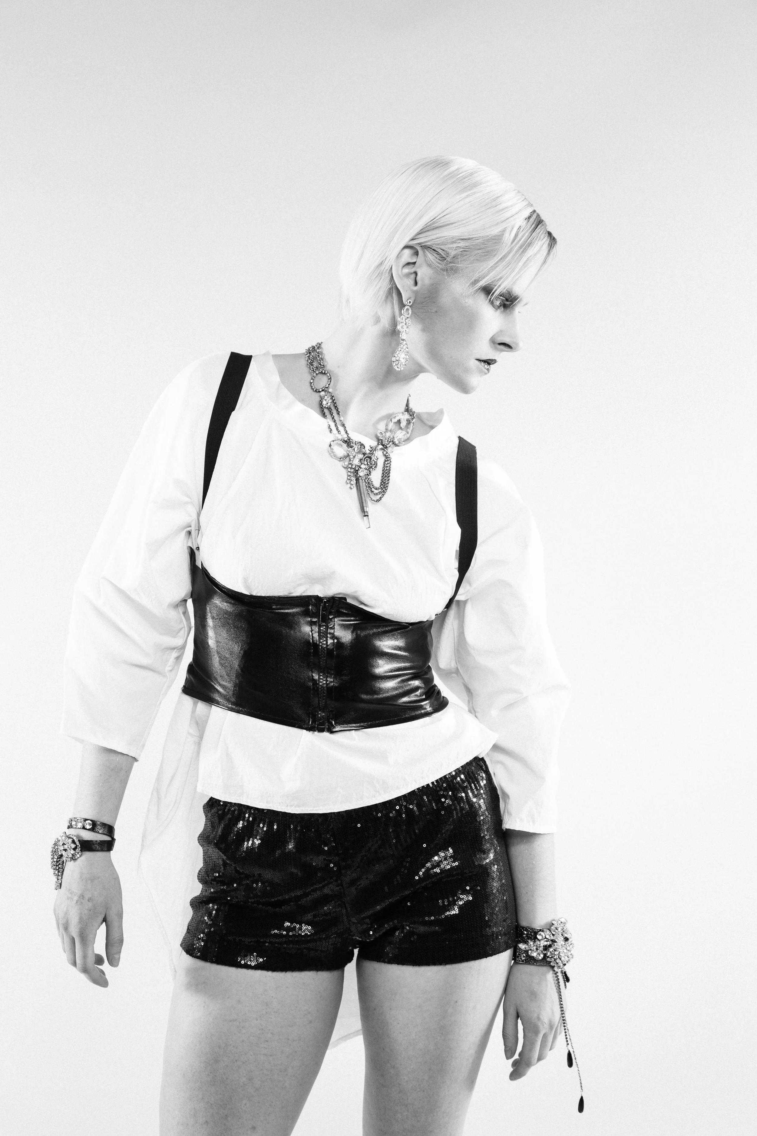 model wearing vintage assemblage with a bullet crystal pendant necklace