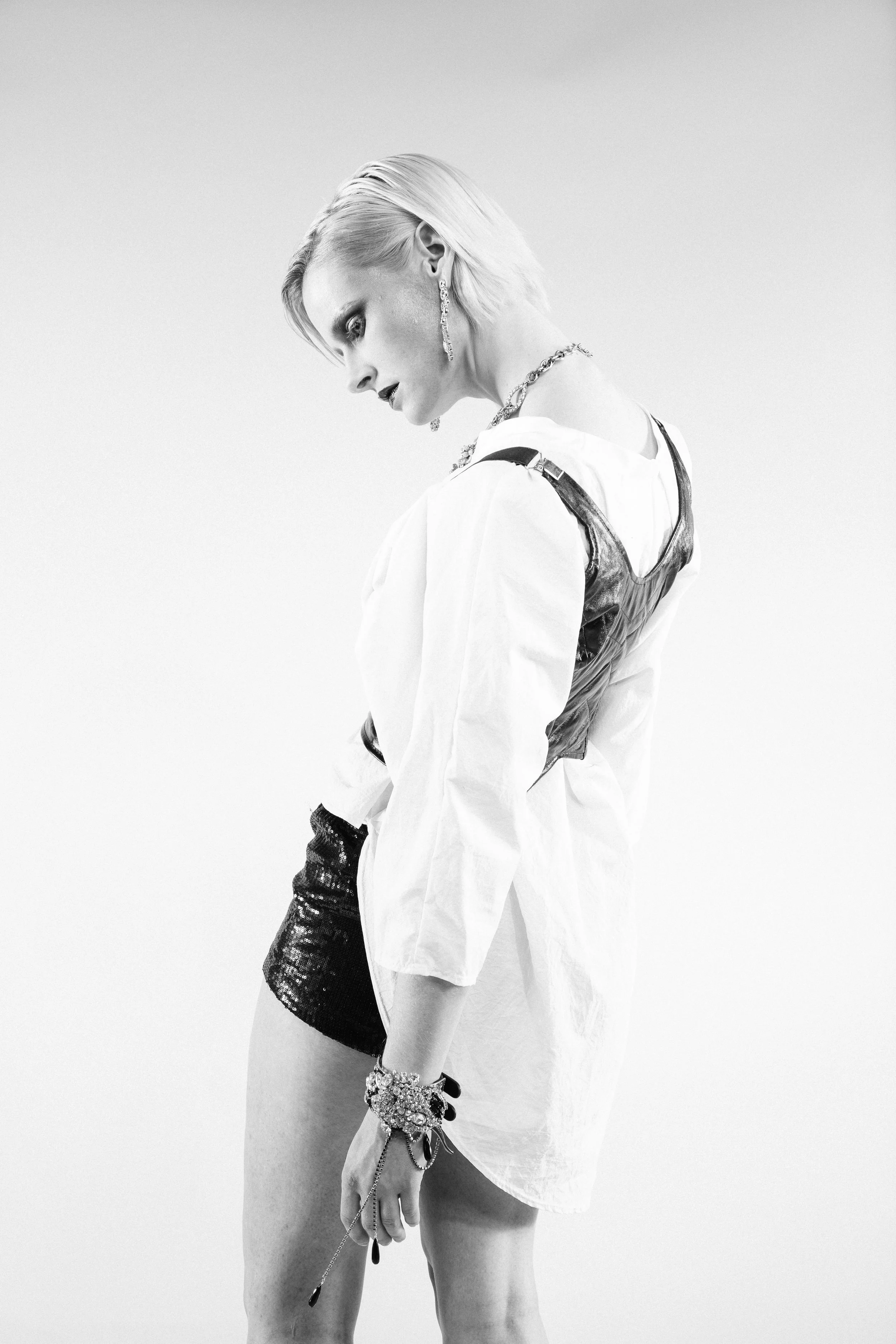 model wearing vintage assemblage with a bullet crystal pendant necklace