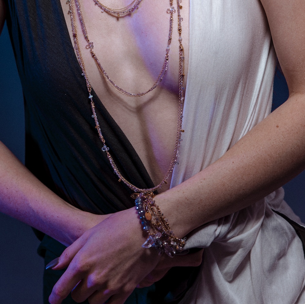 Model wearing layering bracelets gemstone pearl gold layering bracelet