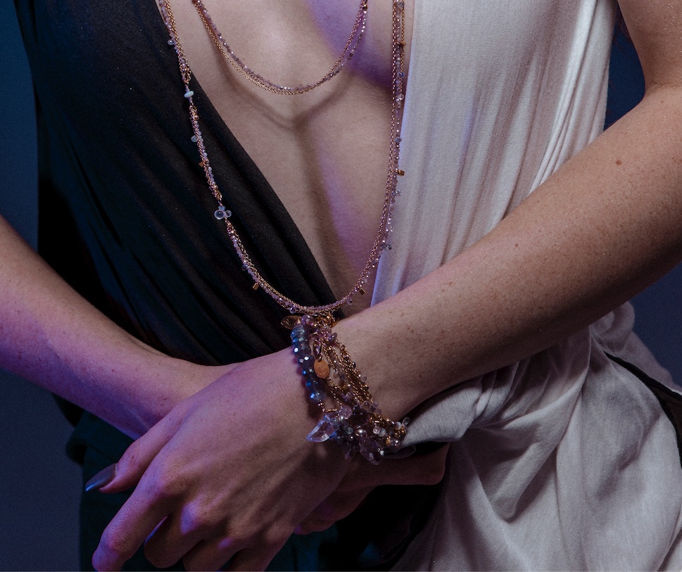 Model wearing layering bracelets