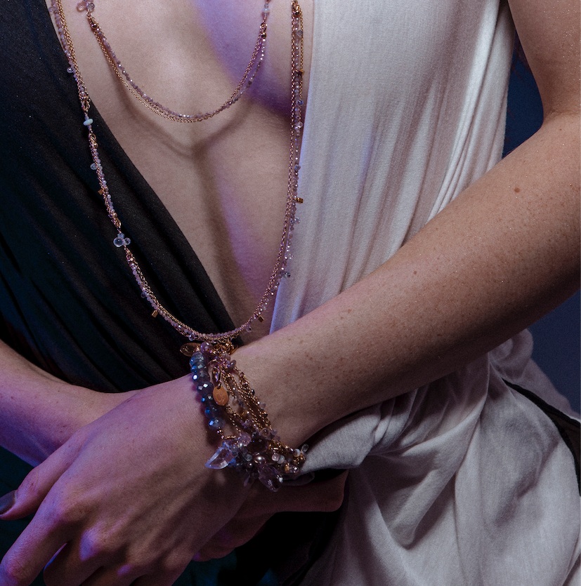 Model wearing layering bracelets gemstone pearl gold layering bracelet