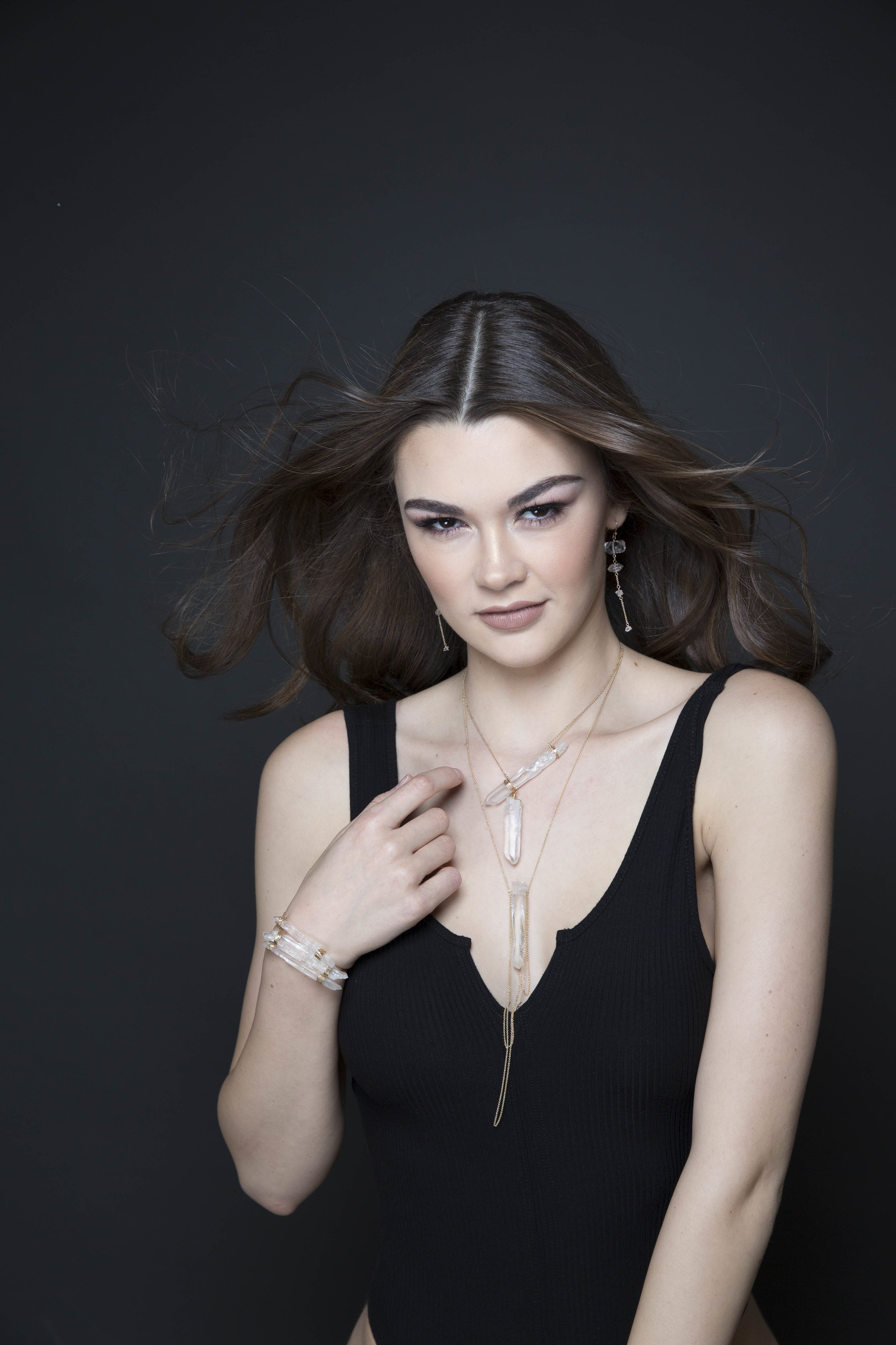 Model wearing asymmetrical crystal point necklace 