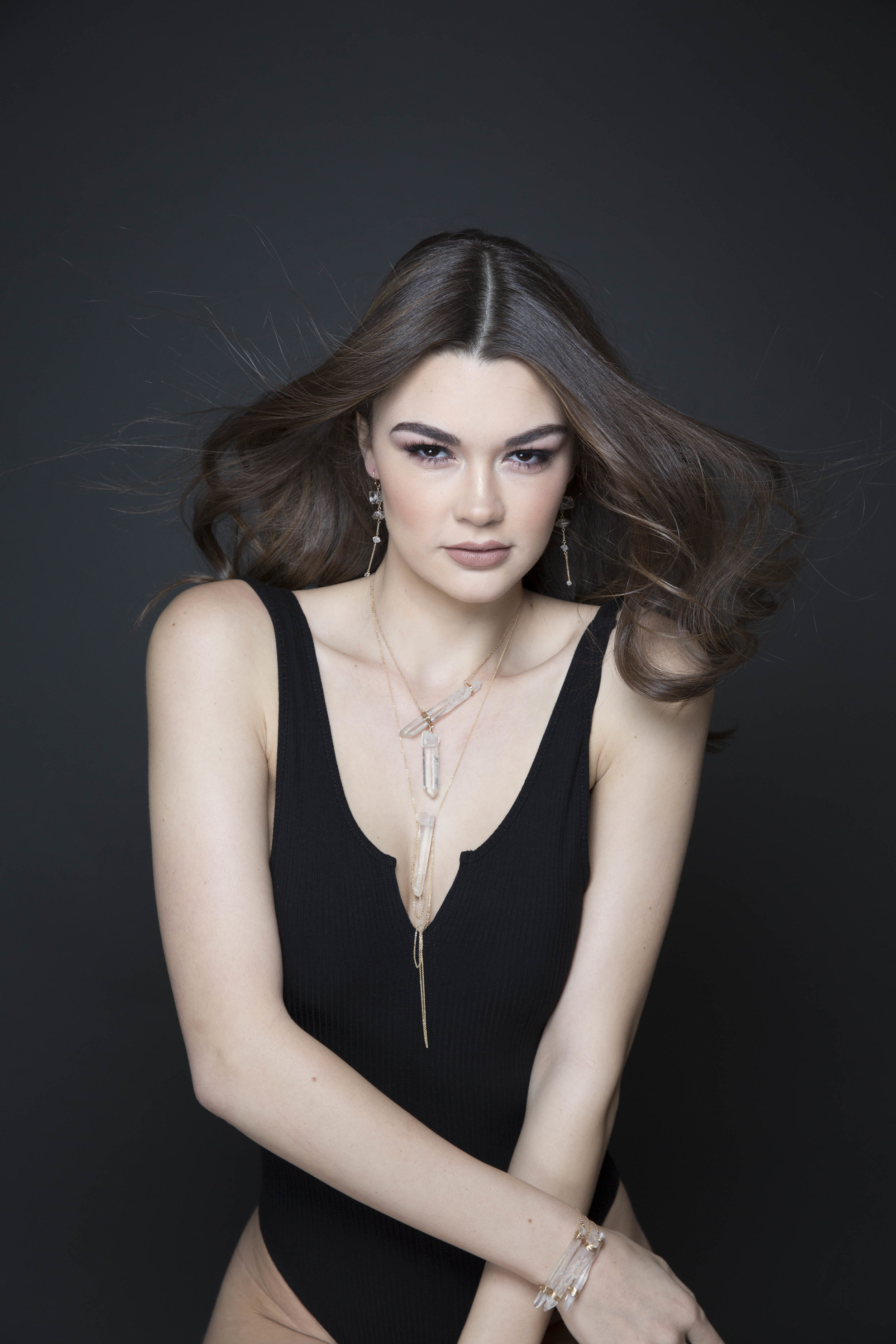Model wearing asymmetrical crystal point necklace 