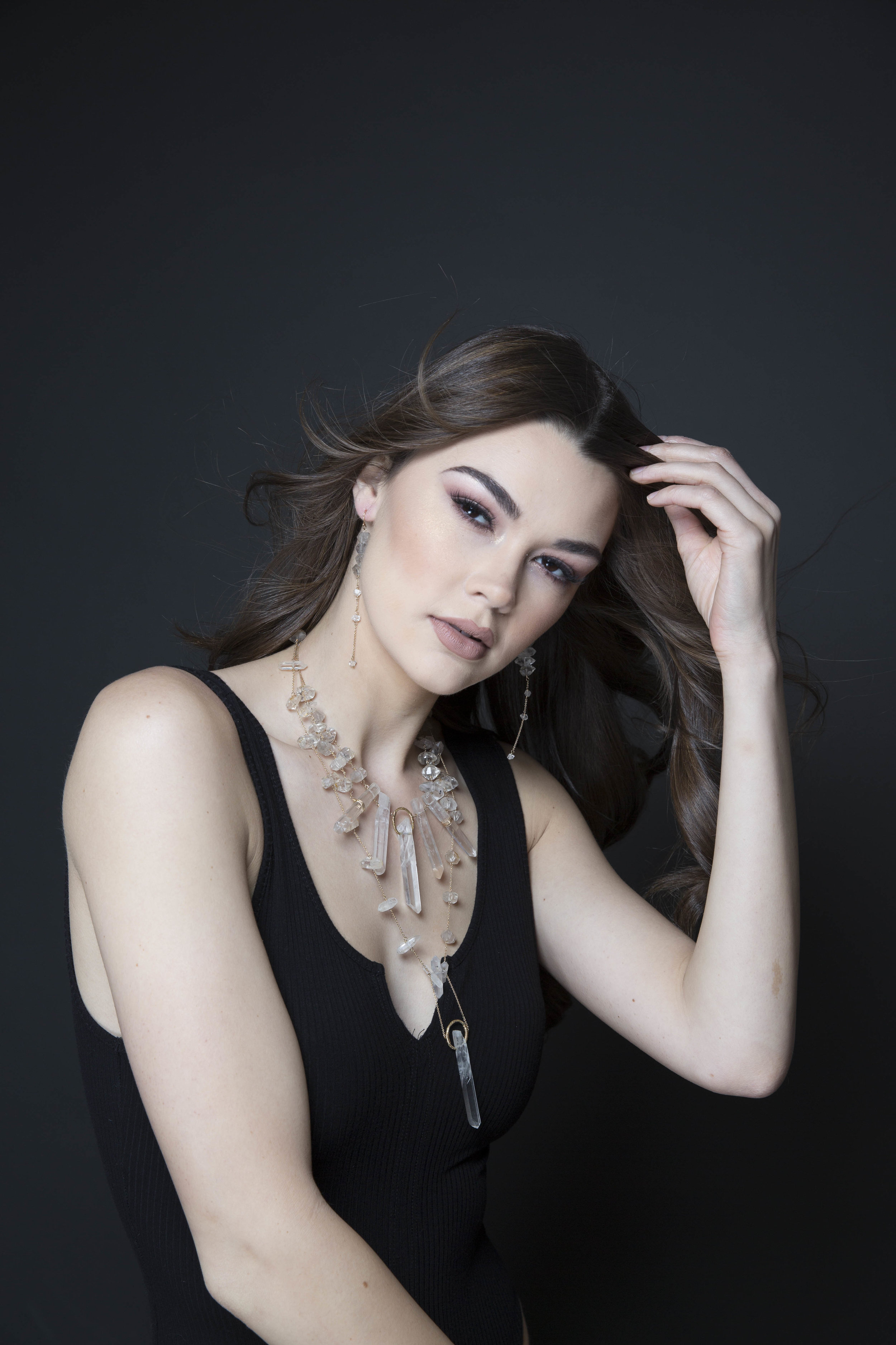 Model wearing a crystal point statement necklace