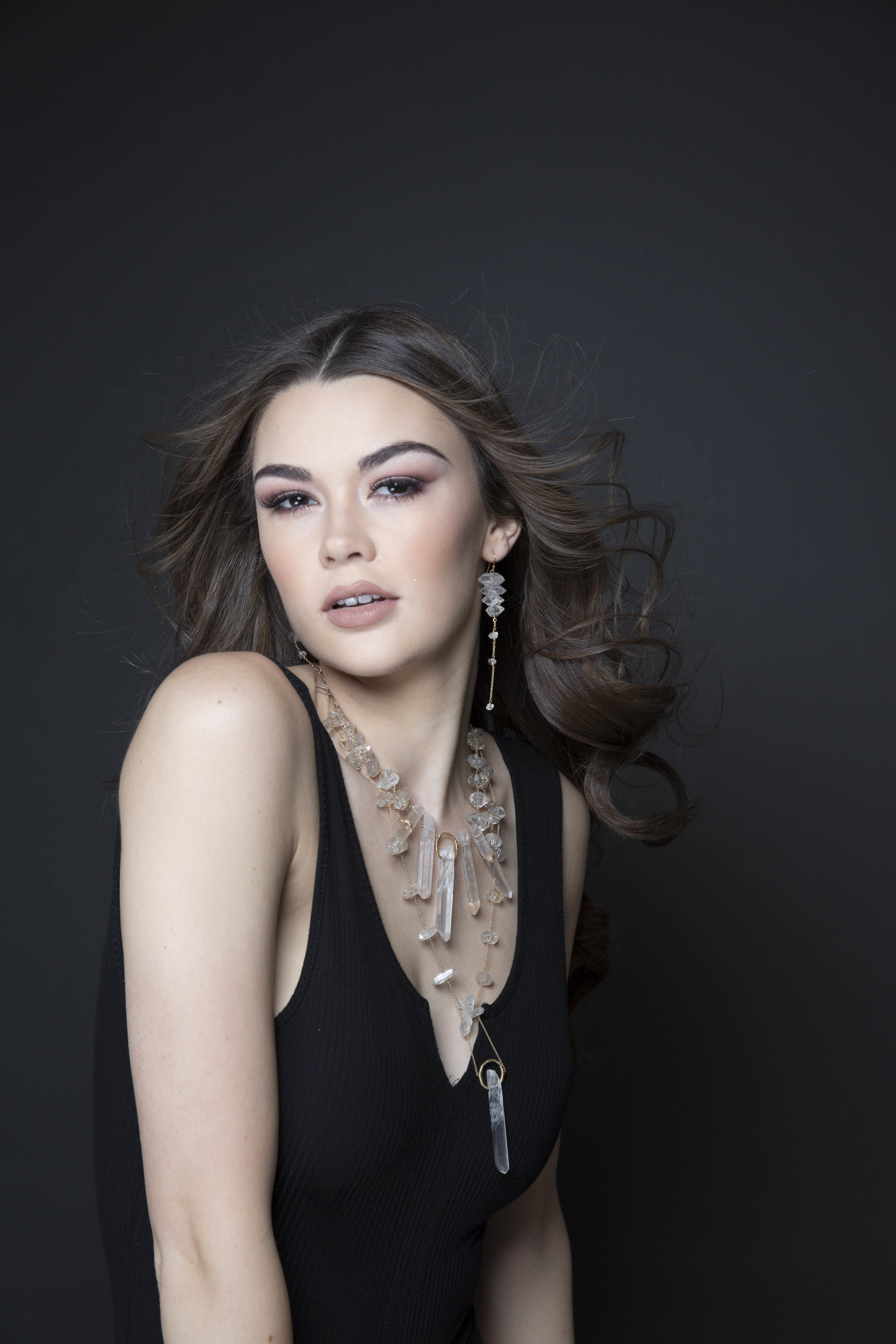 Model wearing a crystal point statement necklace