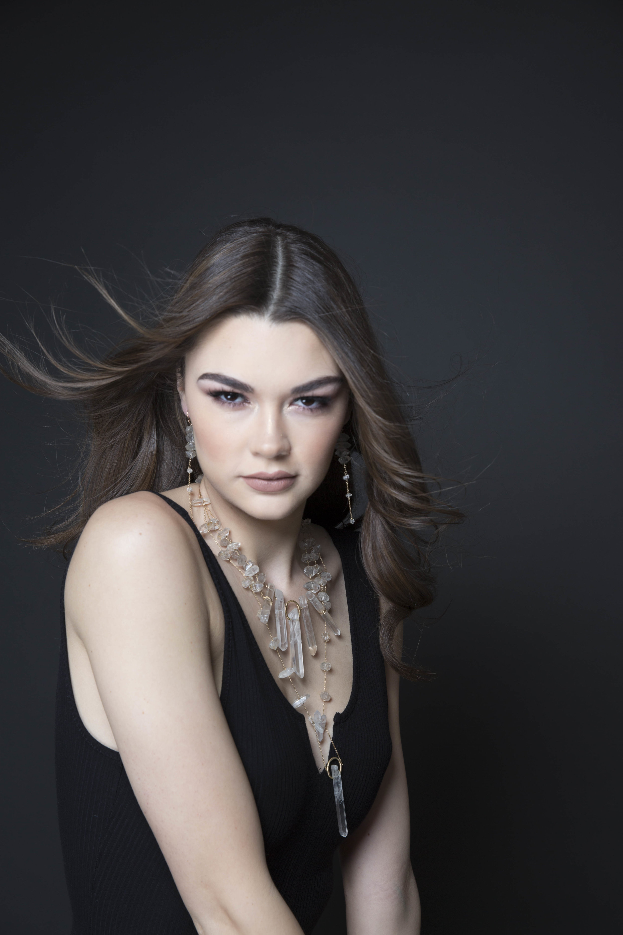 Model wearing a crystal point statement necklace