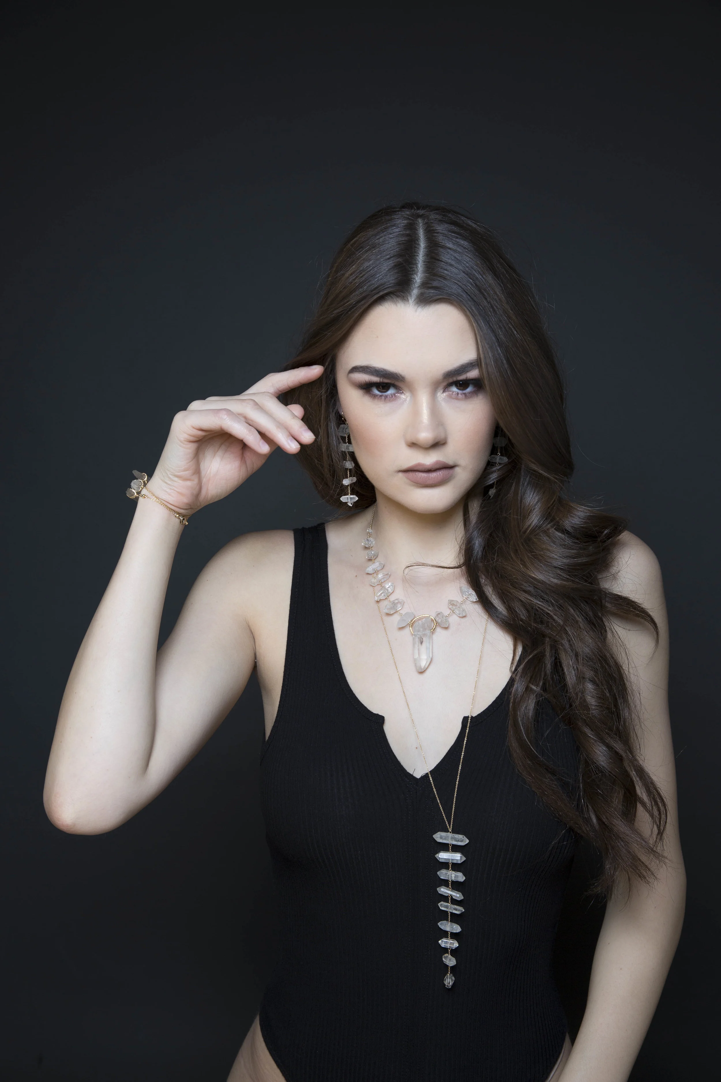Model wearing tiered rock crystal long necklace
