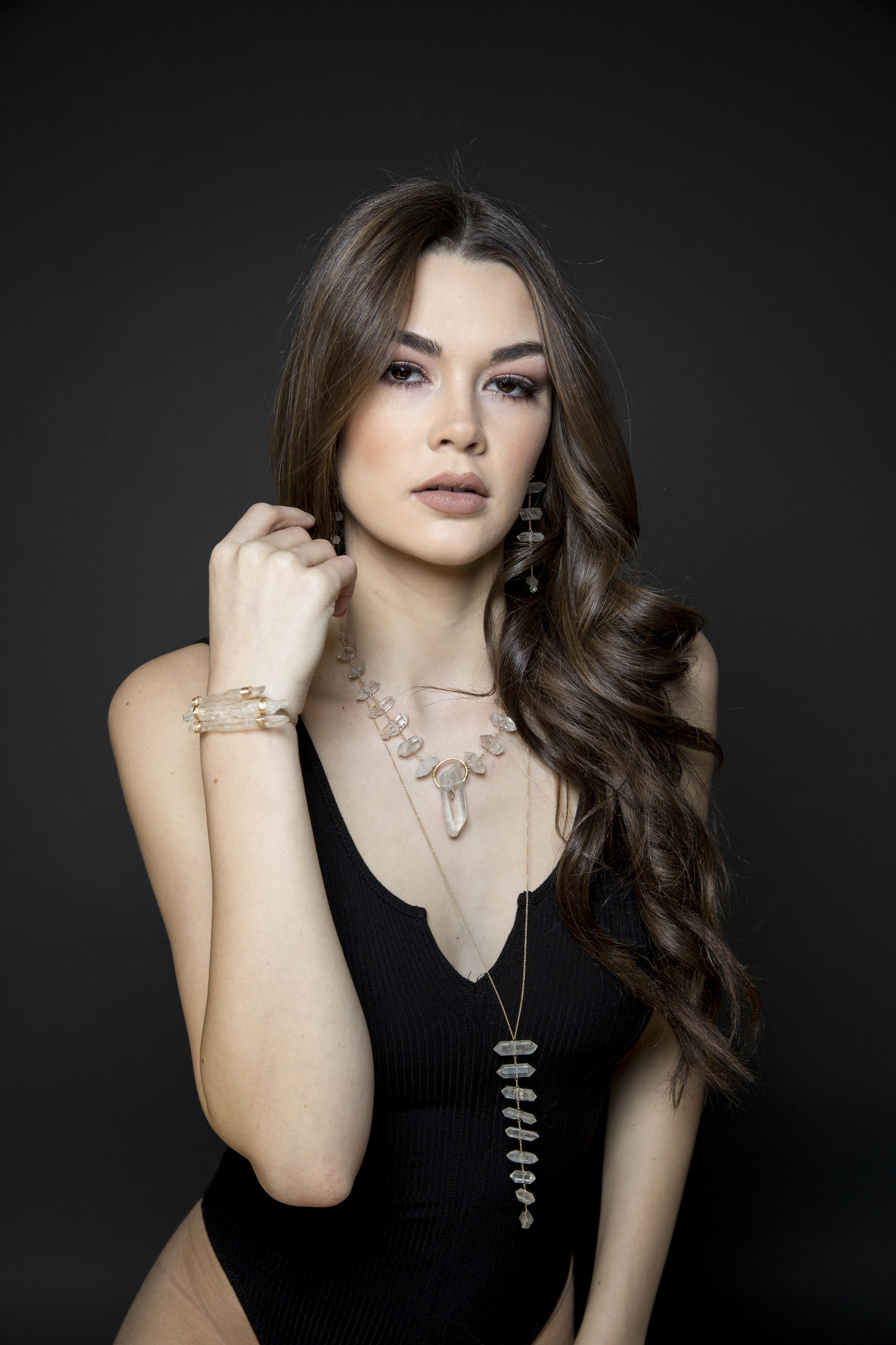 Model wearing tiered rock crystal long necklace