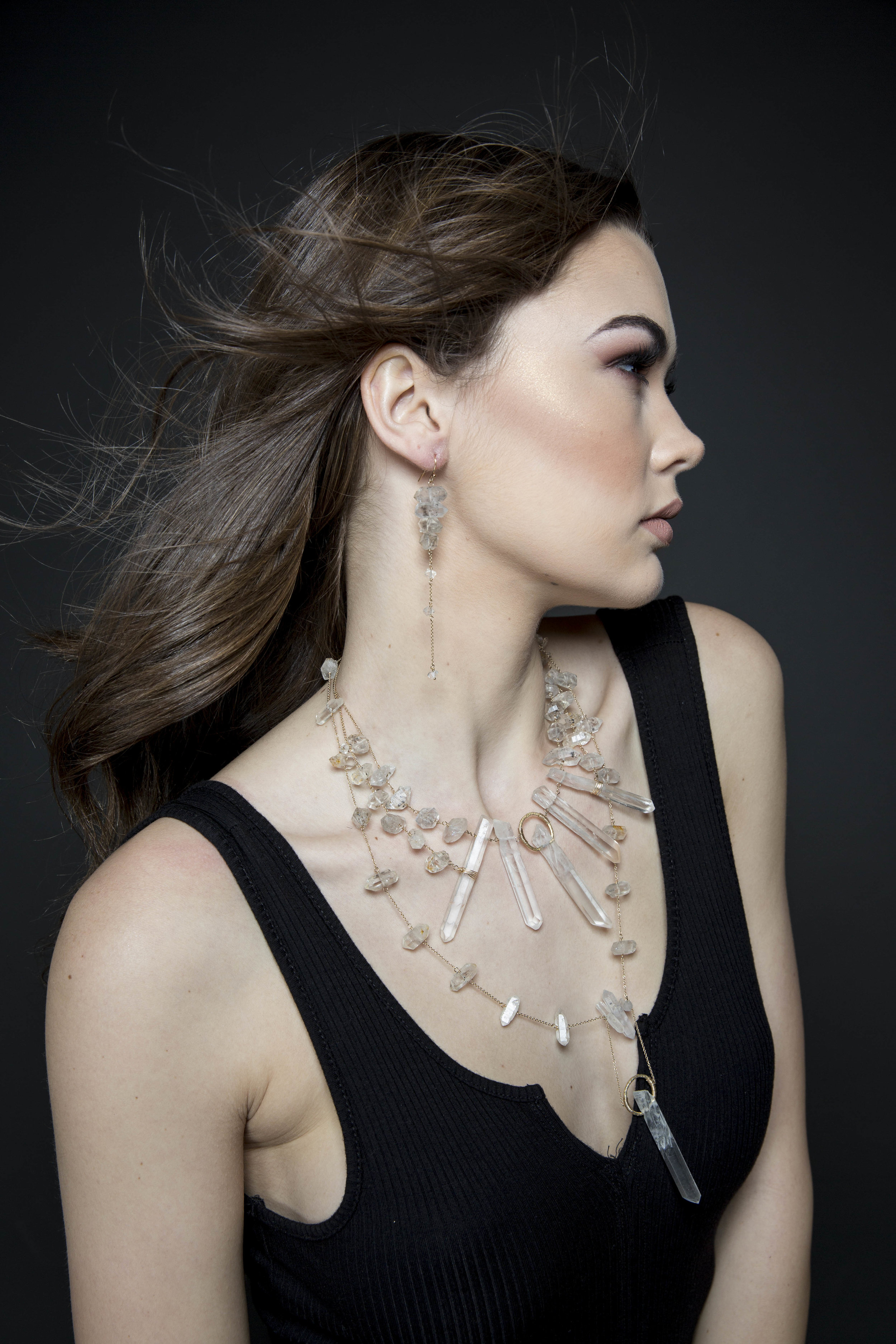 Model wearing tiered crystal long earrings