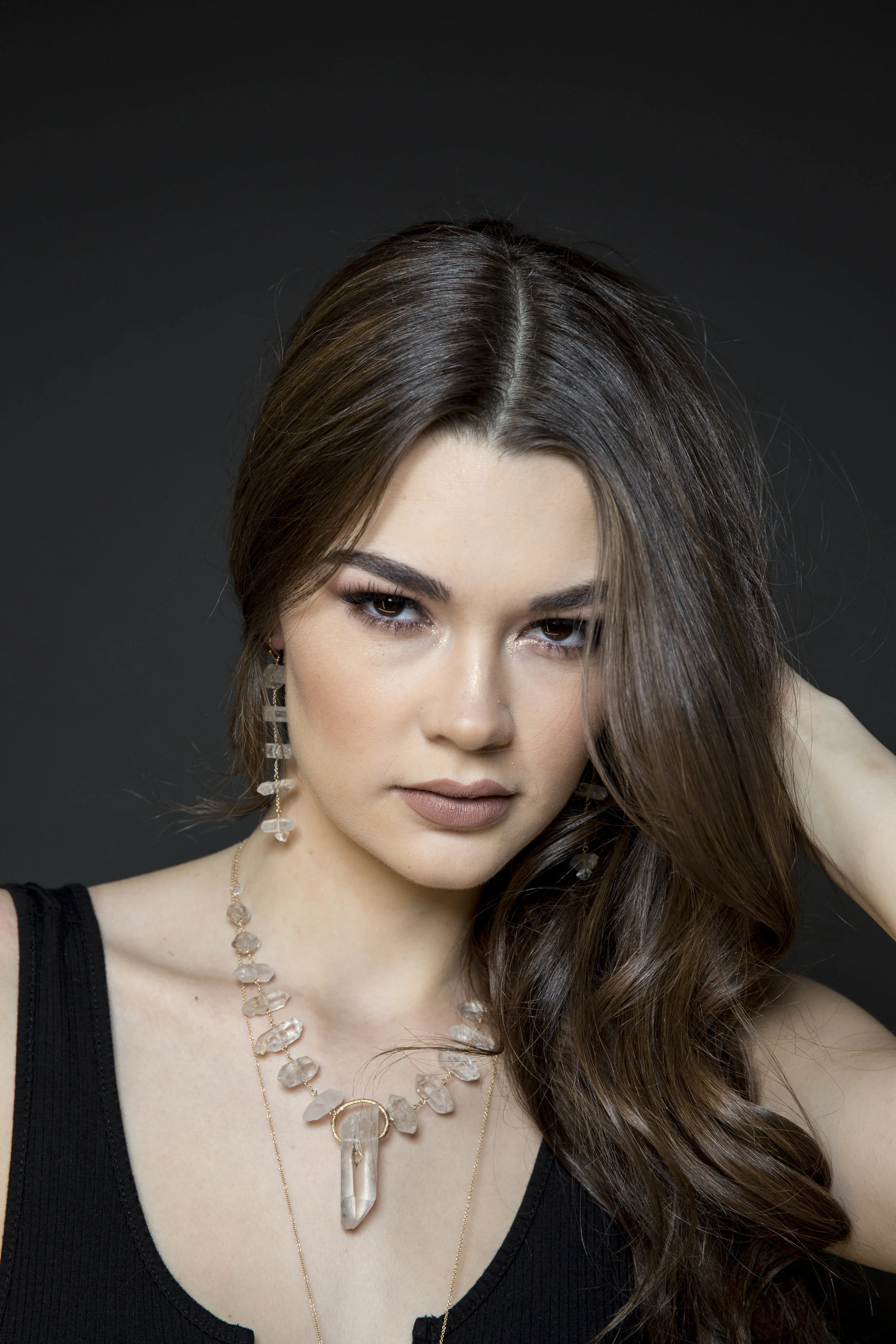 Model wearing tiered crystal drop earrings