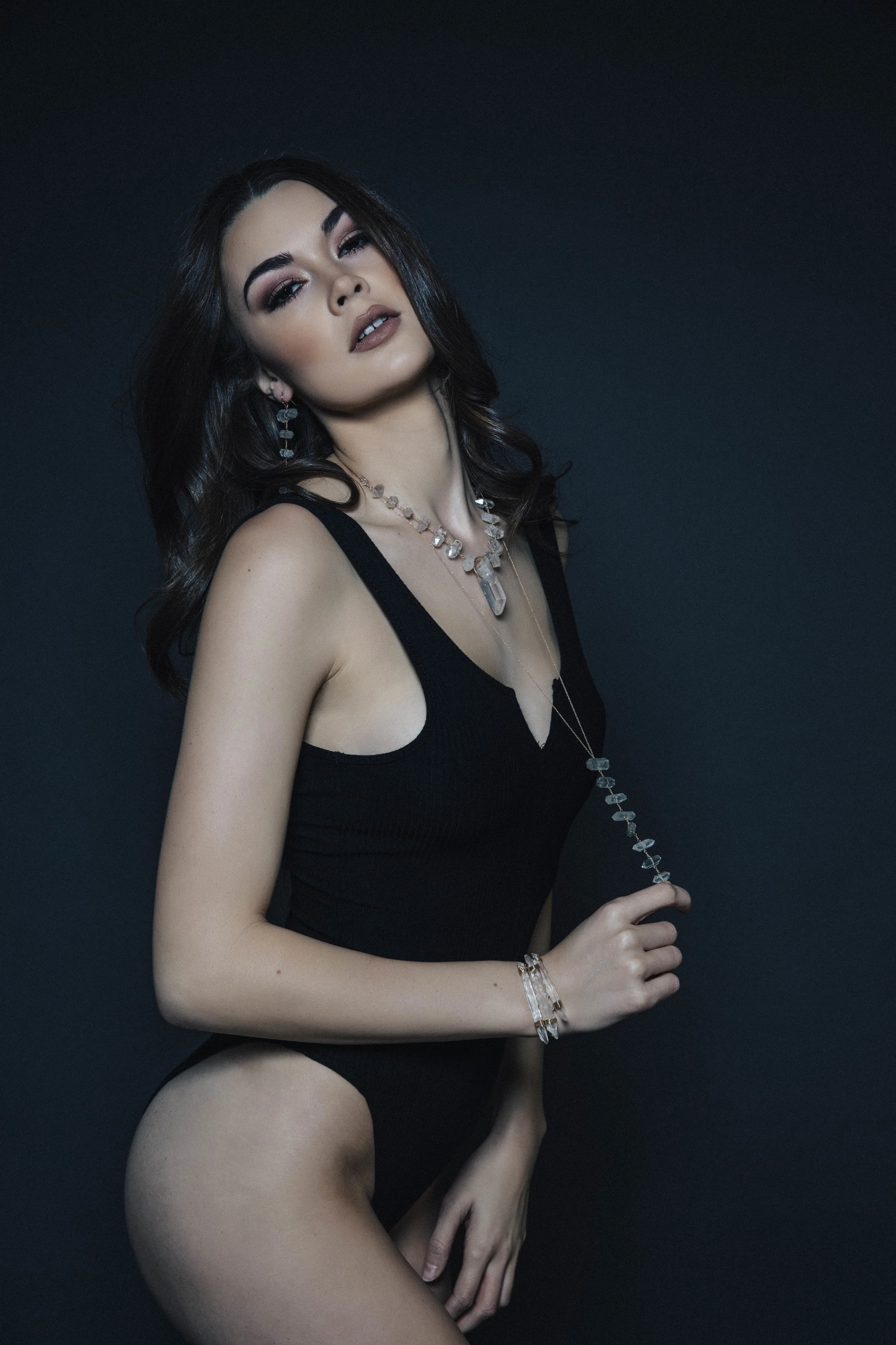 Model wearing tiered crystal drop earrings