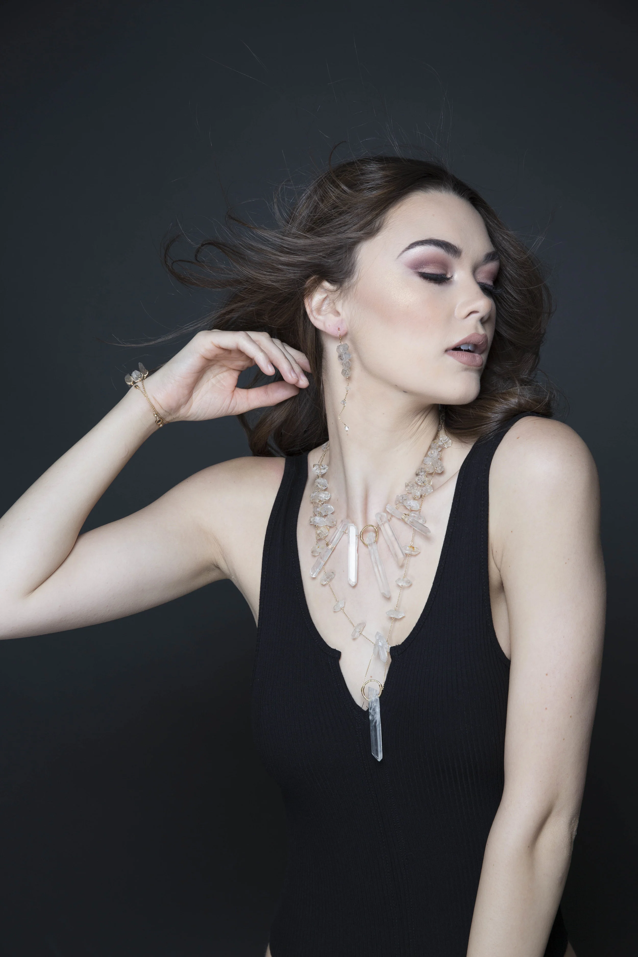 model wearing large crystal point pendant necklace