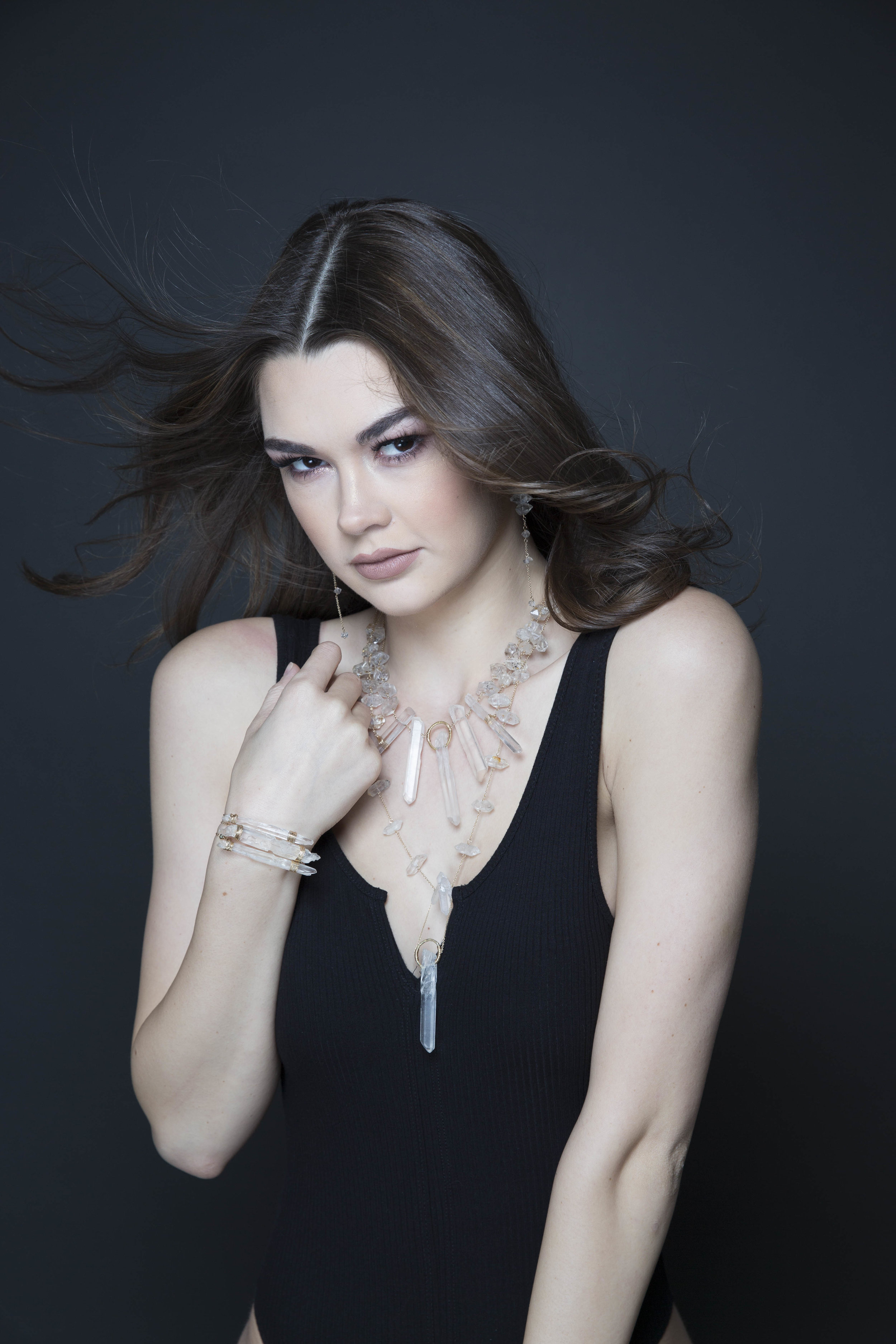 model wearing large crystal point pendant necklace