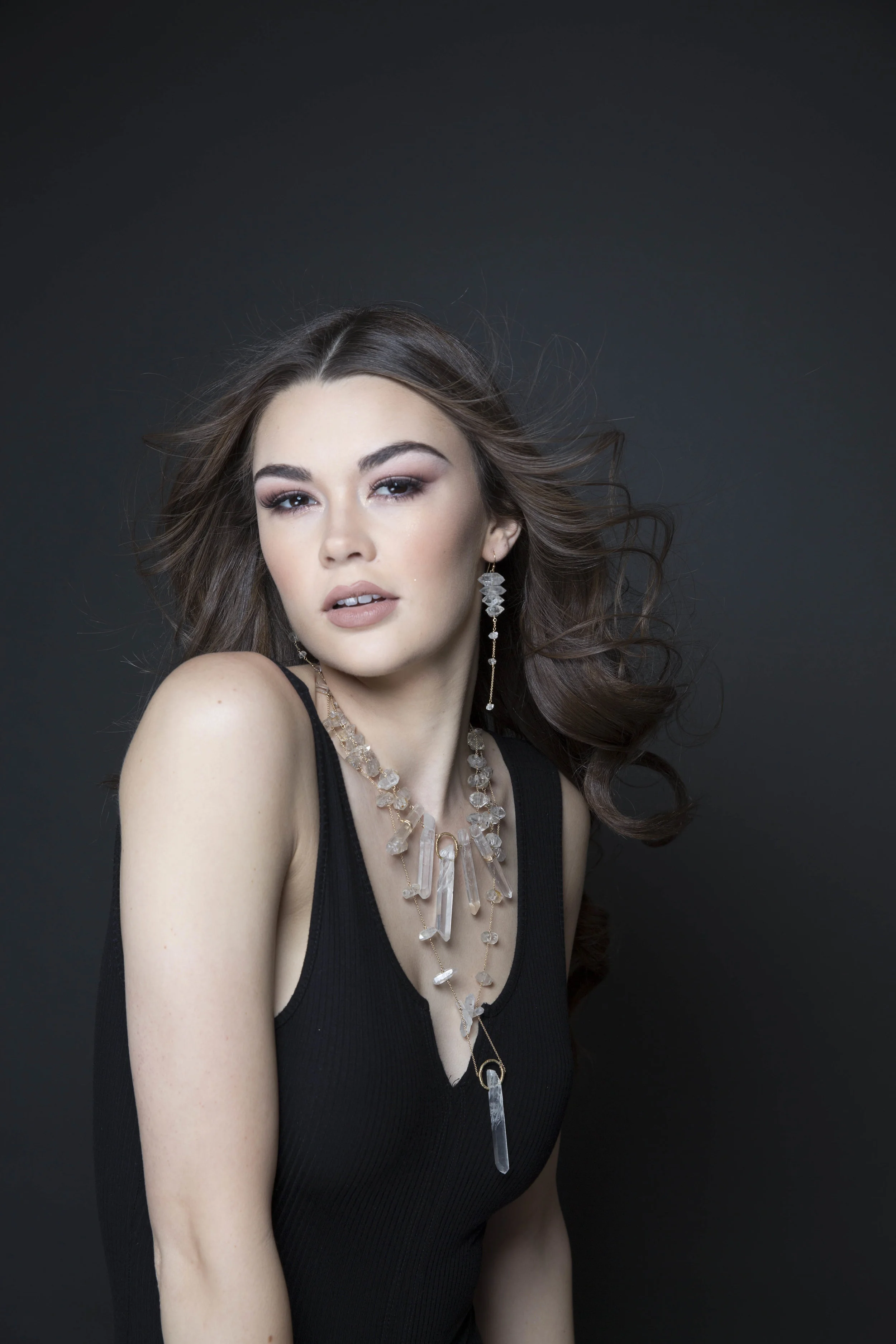 model wearing large crystal point pendant necklace