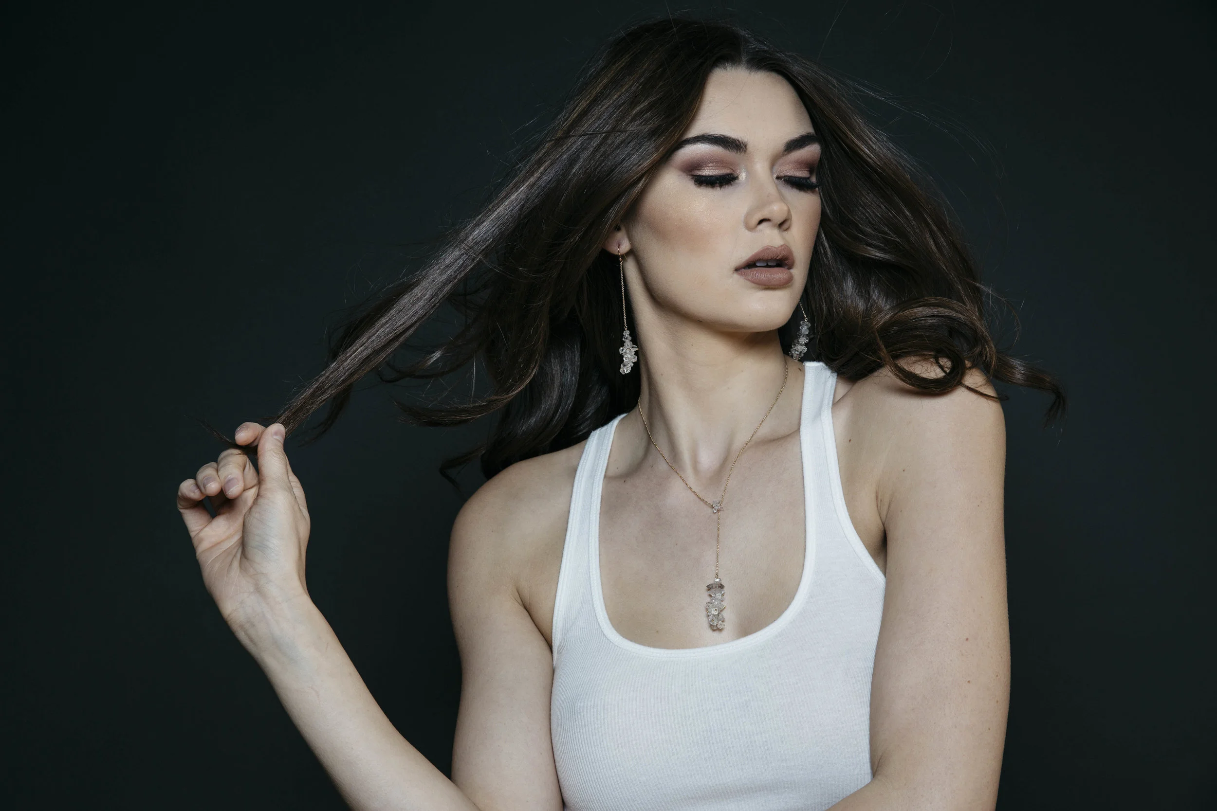 model wearing long pendant crystal drop earrings