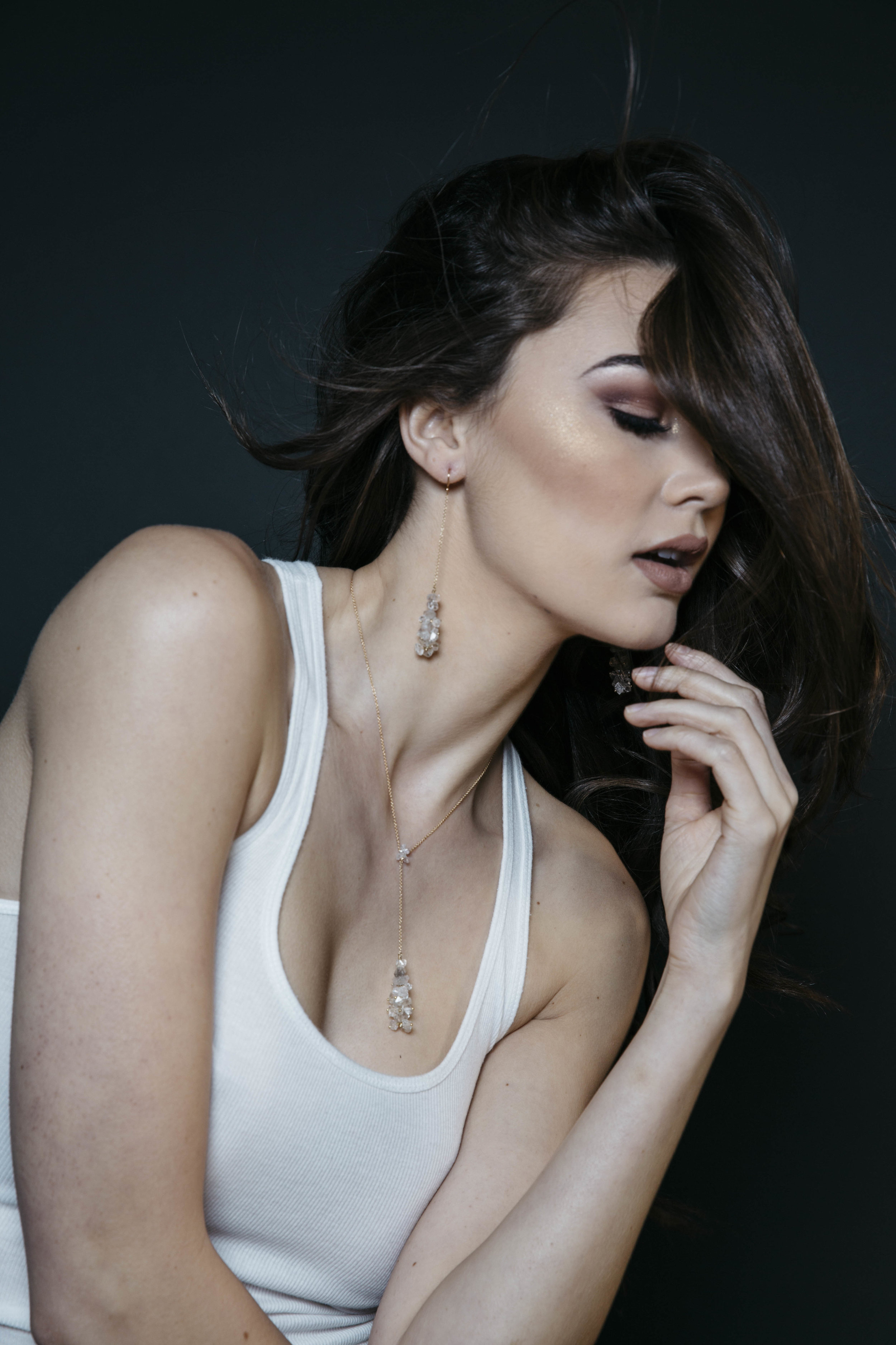 model wearing long pendant crystal drop earrings