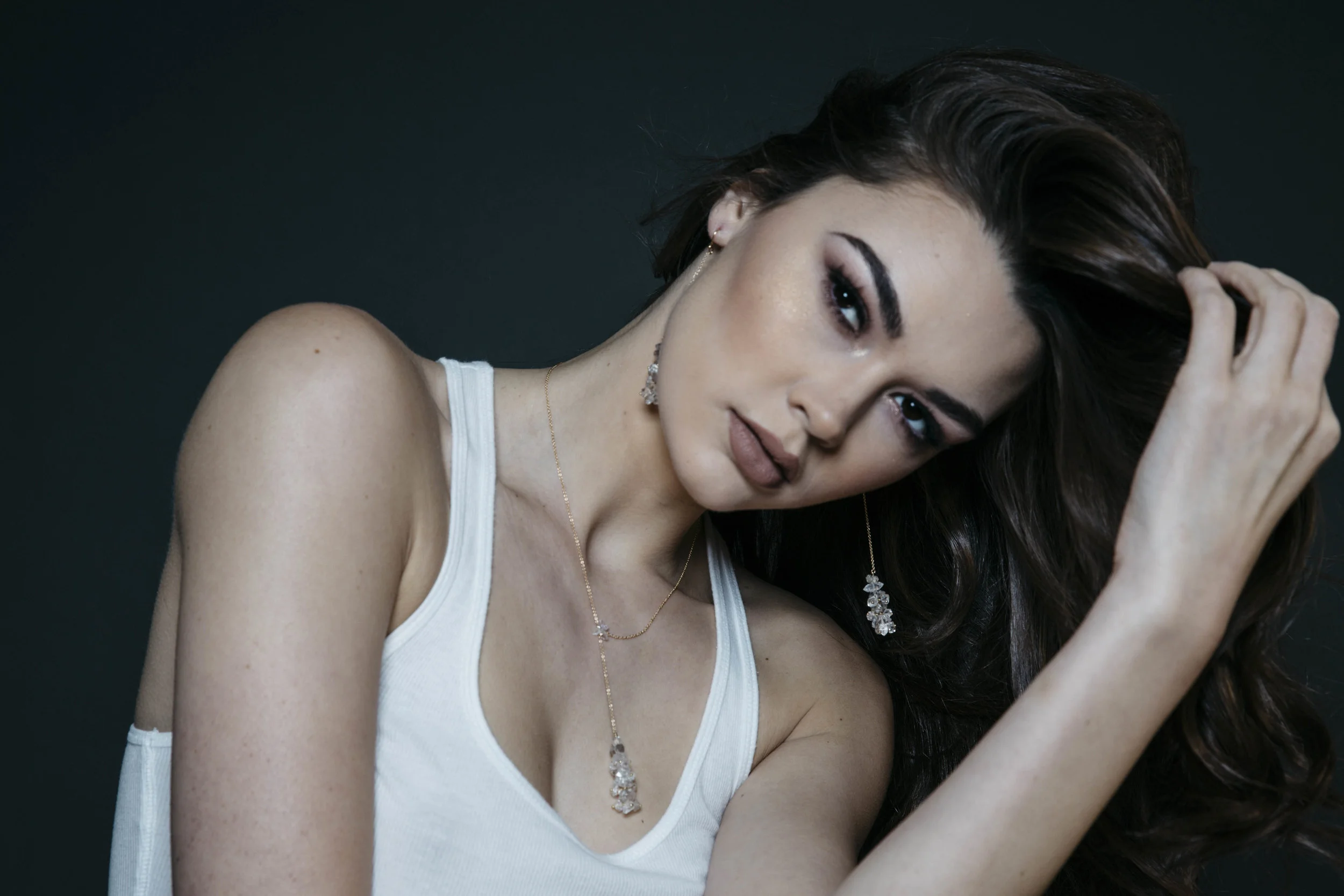 model wearing long pendant crystal drop earrings