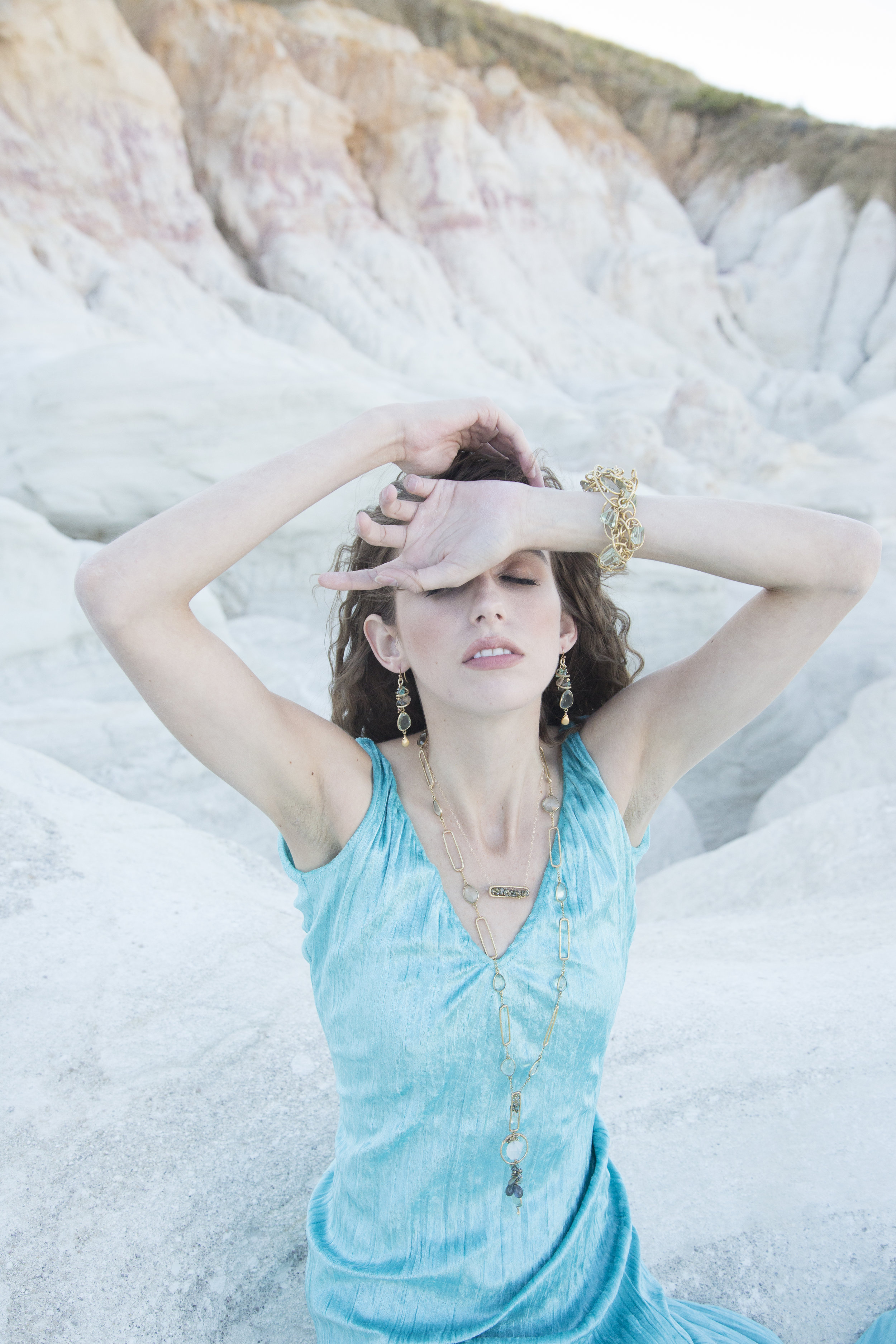 model wearing long gemstone and gold square link necklace