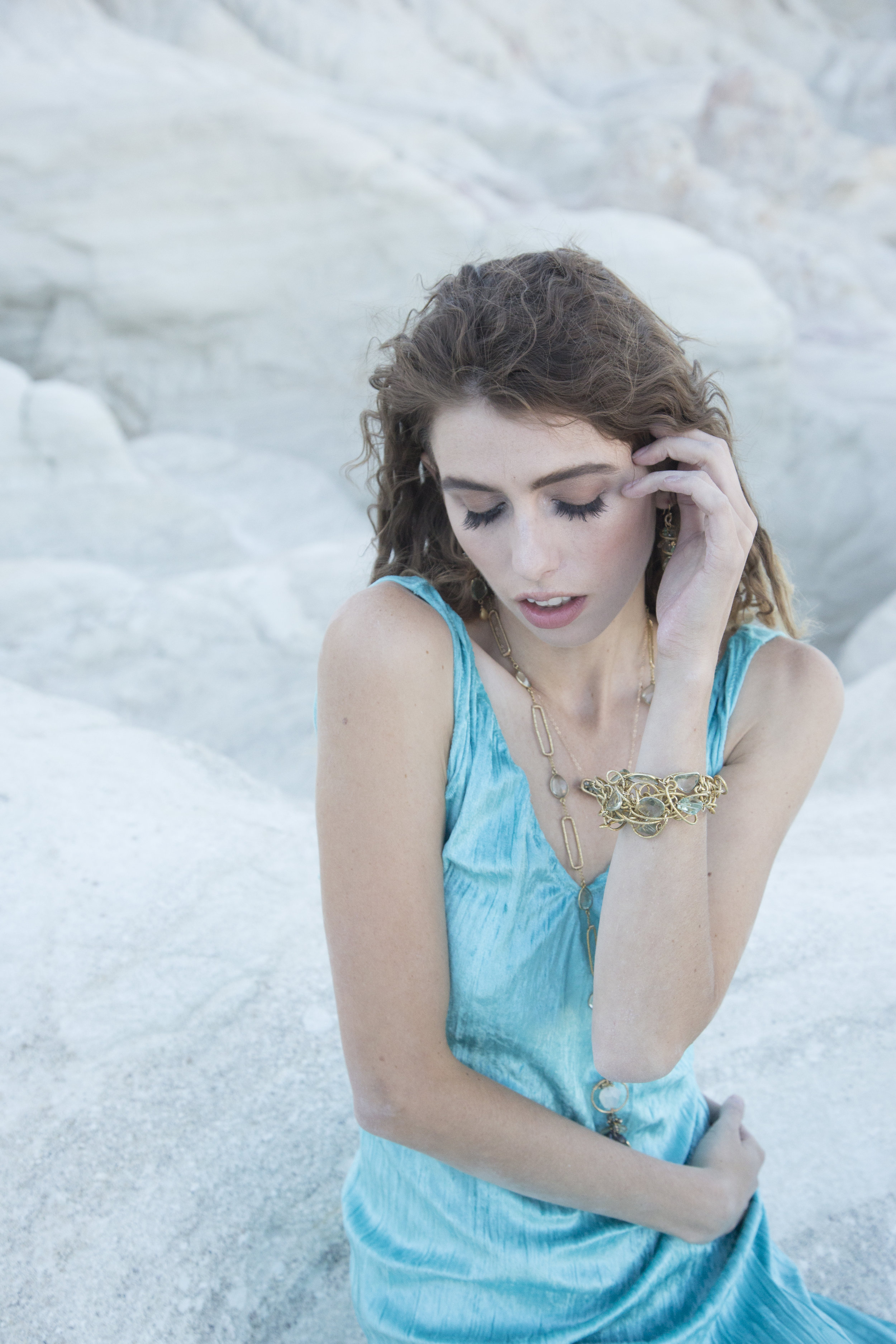 model wearing a gemstone and gold bar necklace