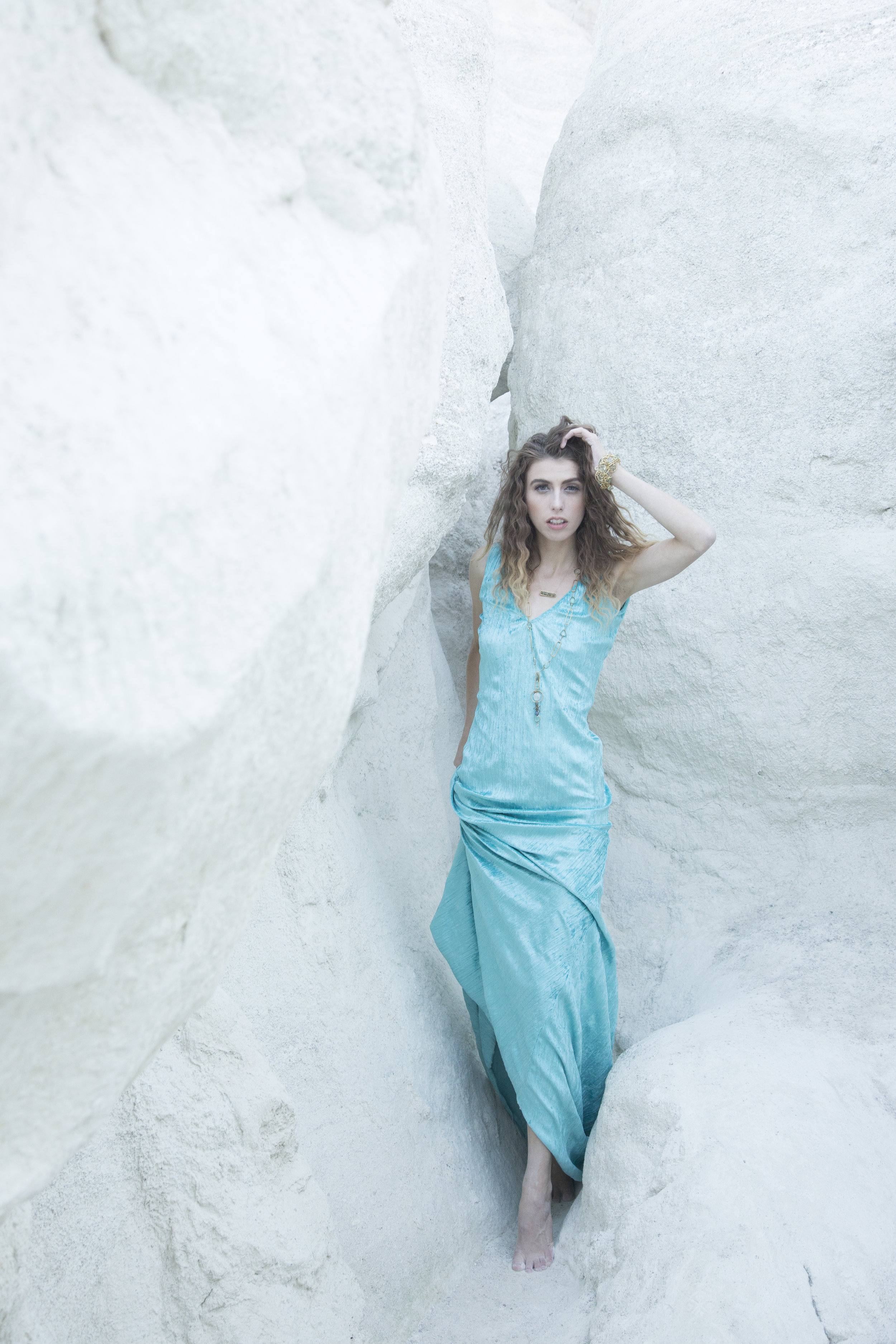 model wearing a gemstone and gold bar necklace