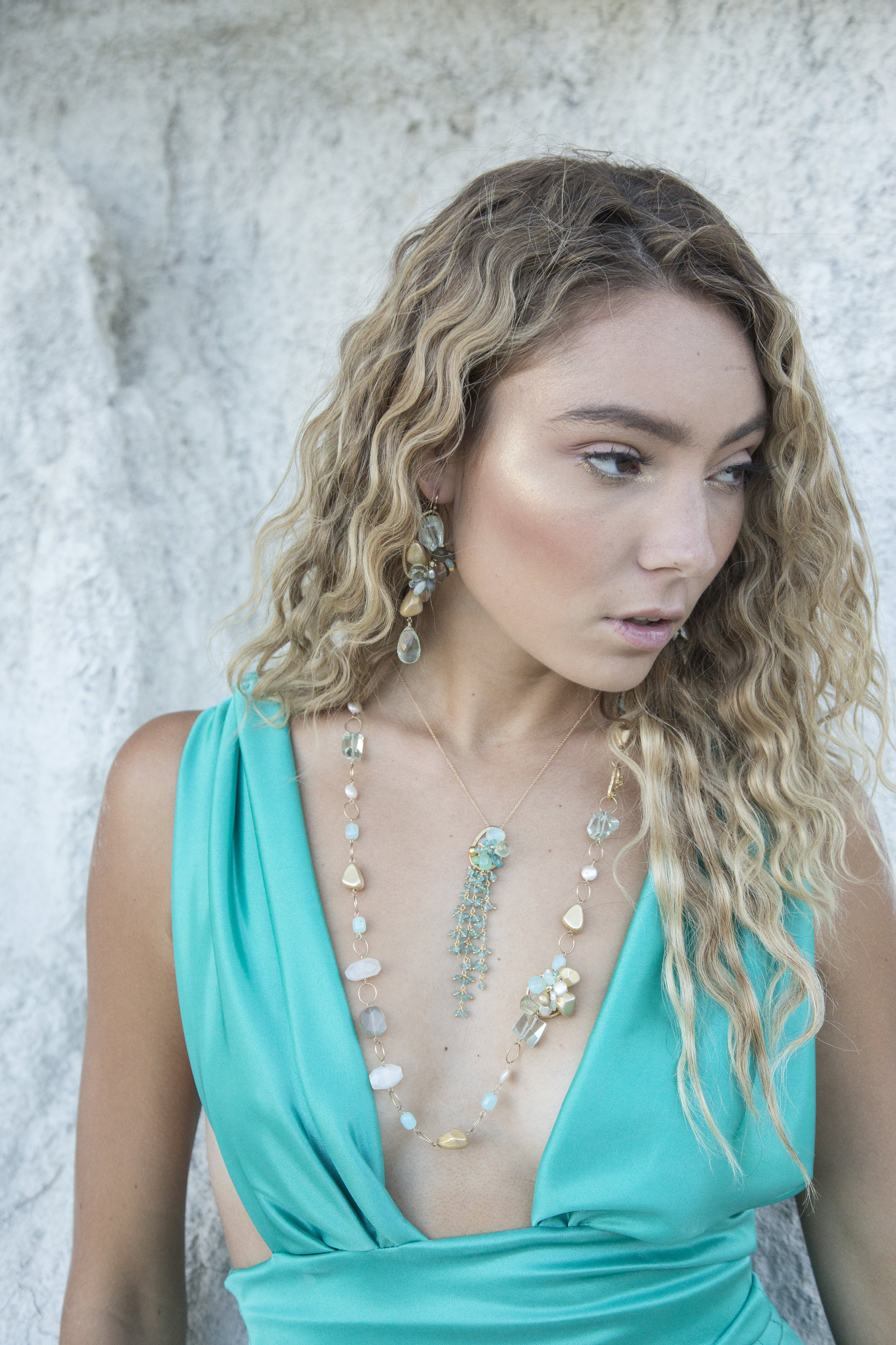 model wearing a apatite tassel and gemstone cluster necklace