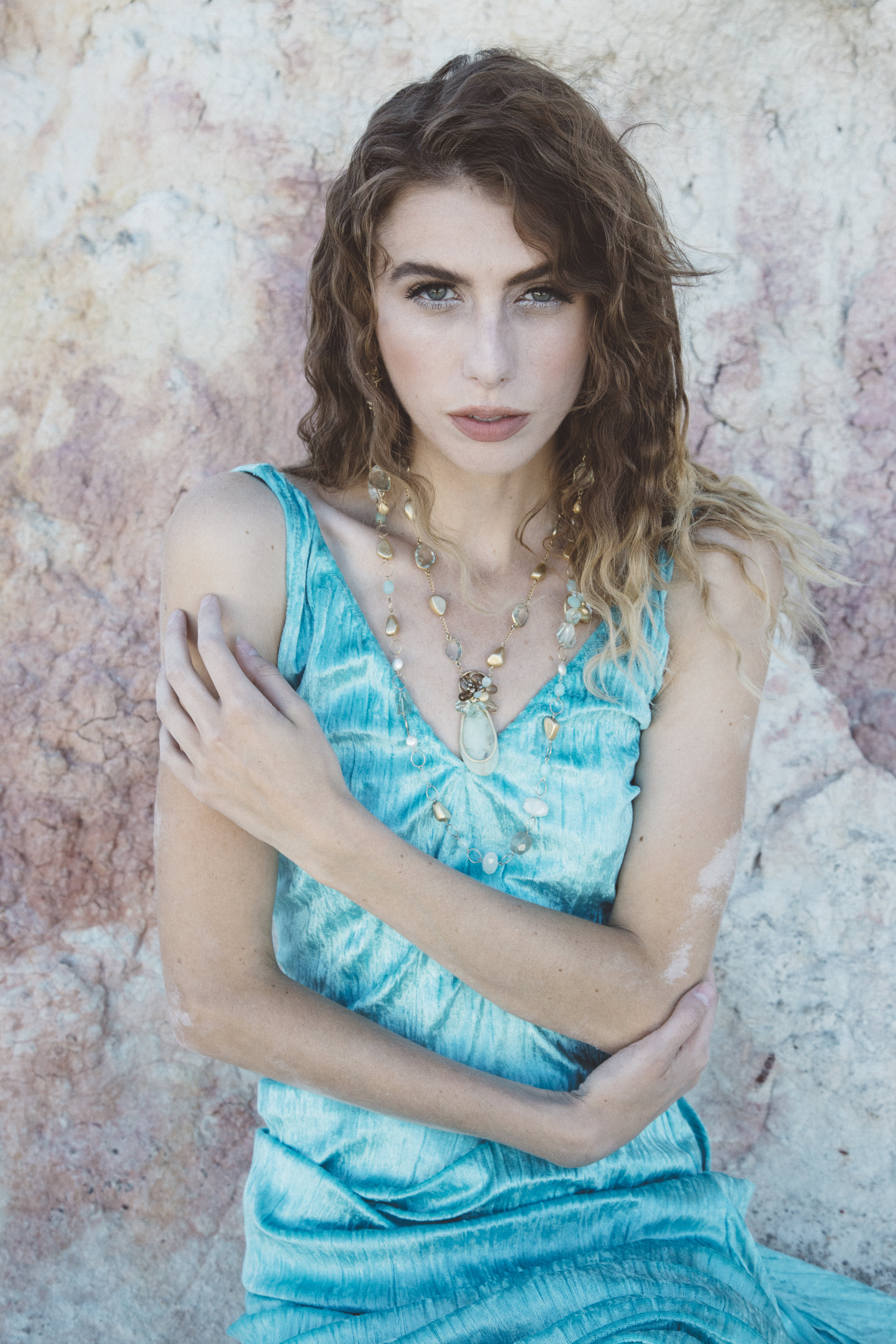 model wearing a peruvian opal pendant and gold necklace